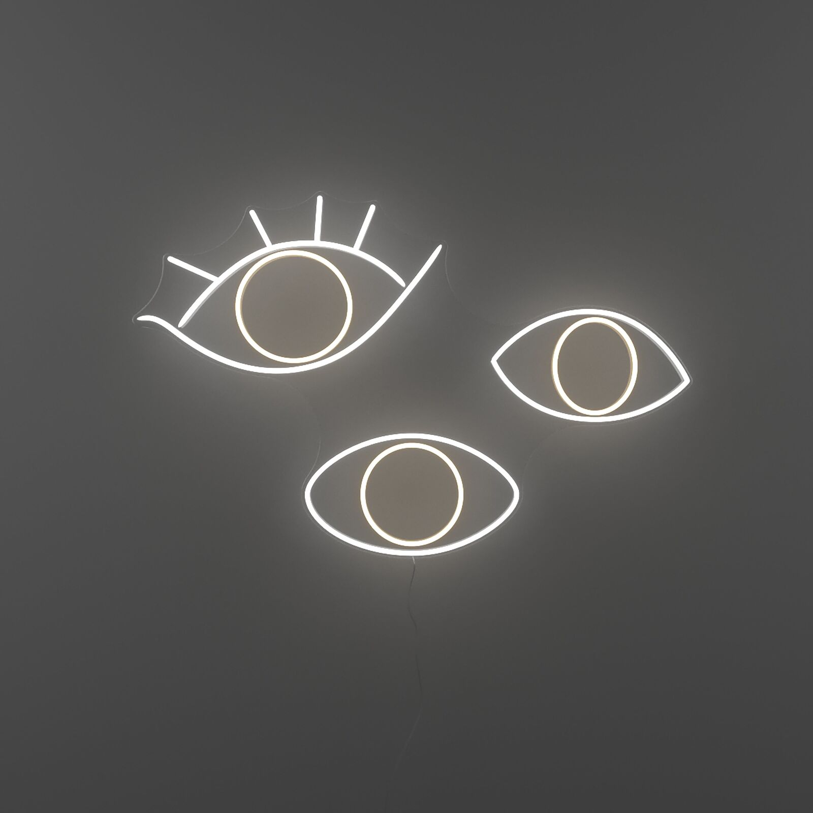 A neon sign with three eyes on a gray background.