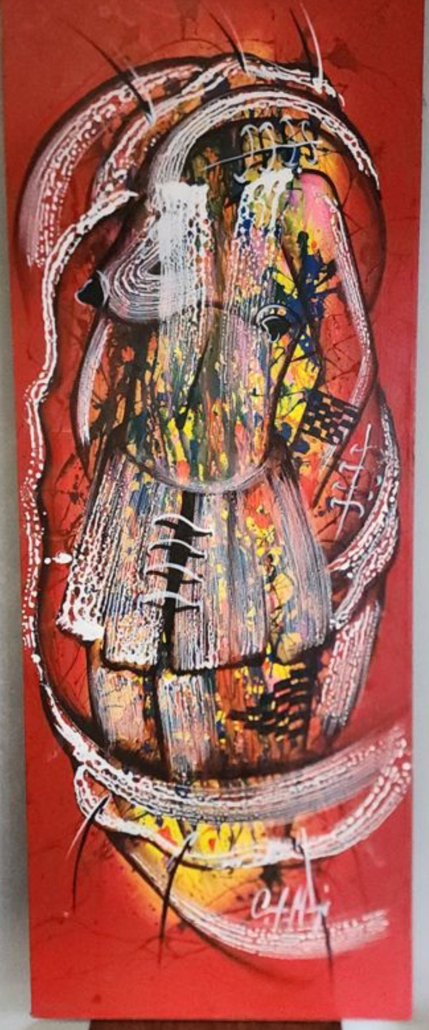 A person in a black shirt and light pants stands in an art gallery, gazing at a tall red canvas featuring an abstract, face-like composition with white brushstrokes.