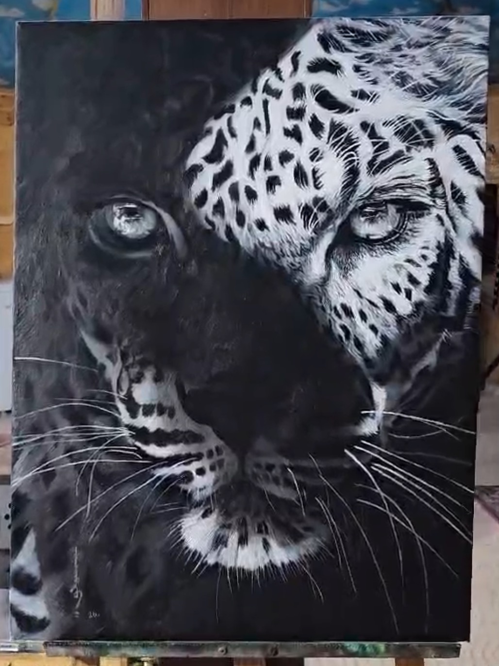 A striking black-and-white portrait of two leopards merging into a single face.