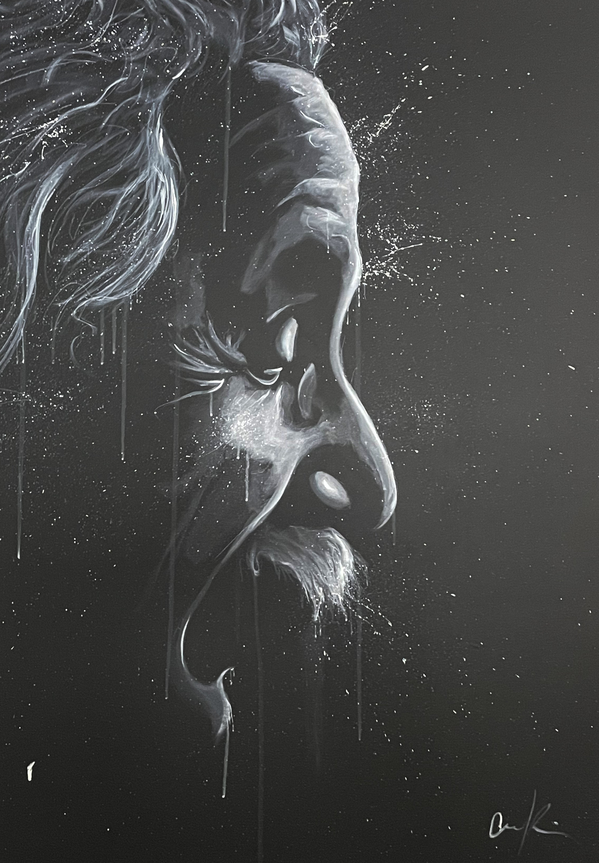 A contemplative figure stands before a dramatic black-and-white portrait in an art gallery.