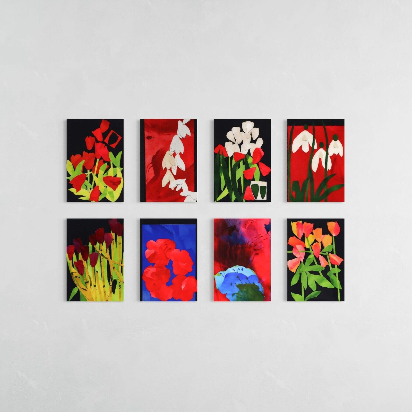 A set of six paintings of flowers on a white wall.