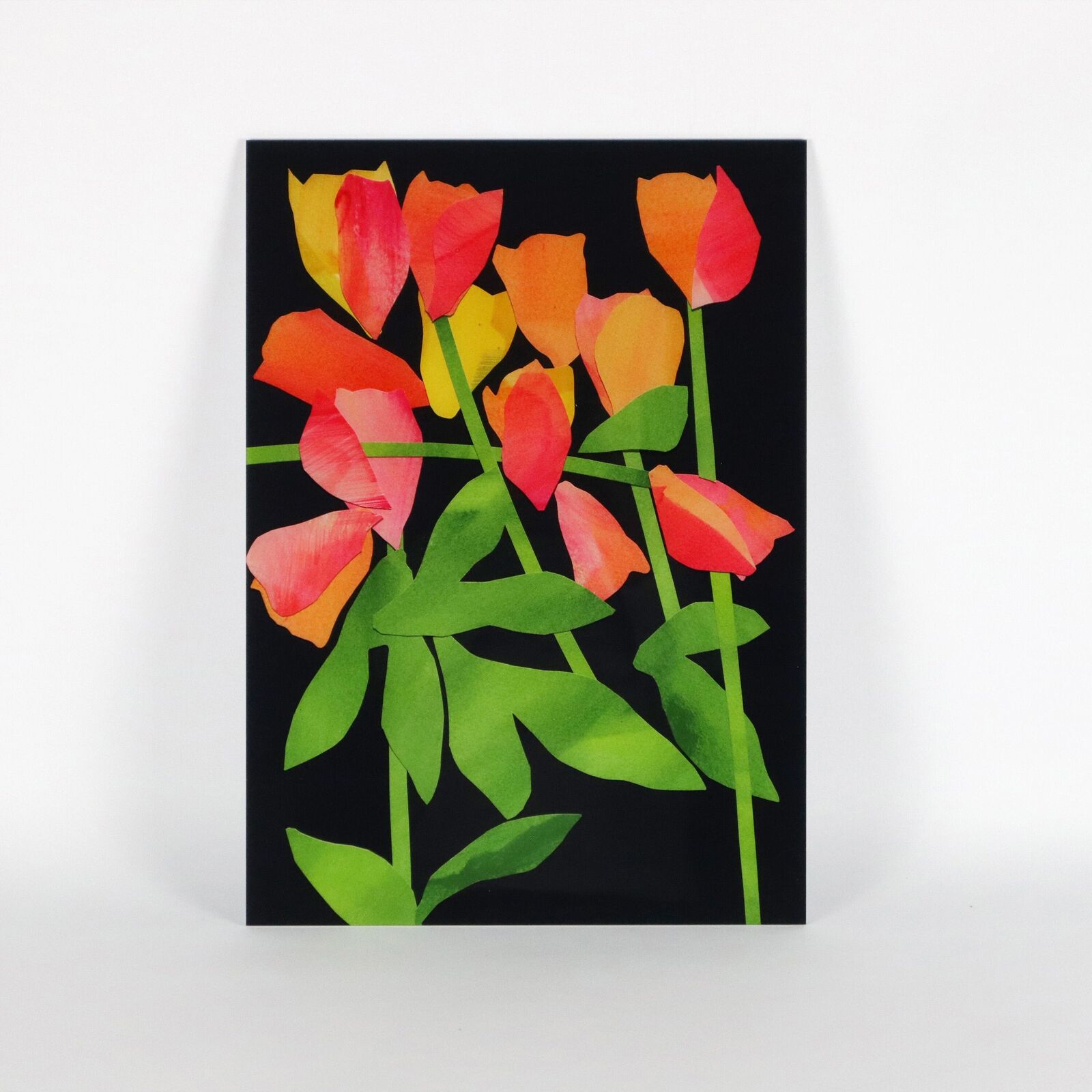 A set of six paintings of flowers on a white wall.