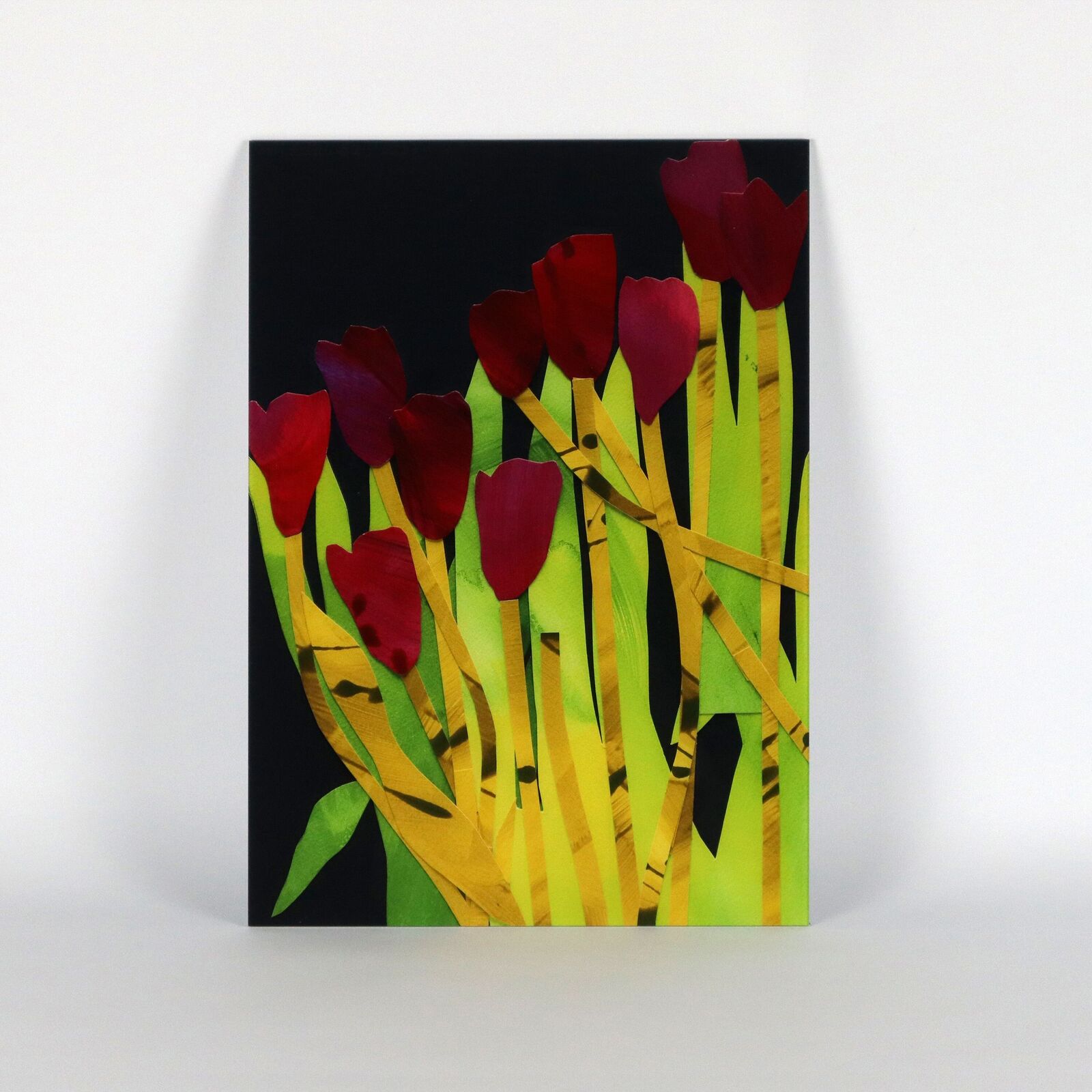 A set of six paintings of flowers on a white wall.