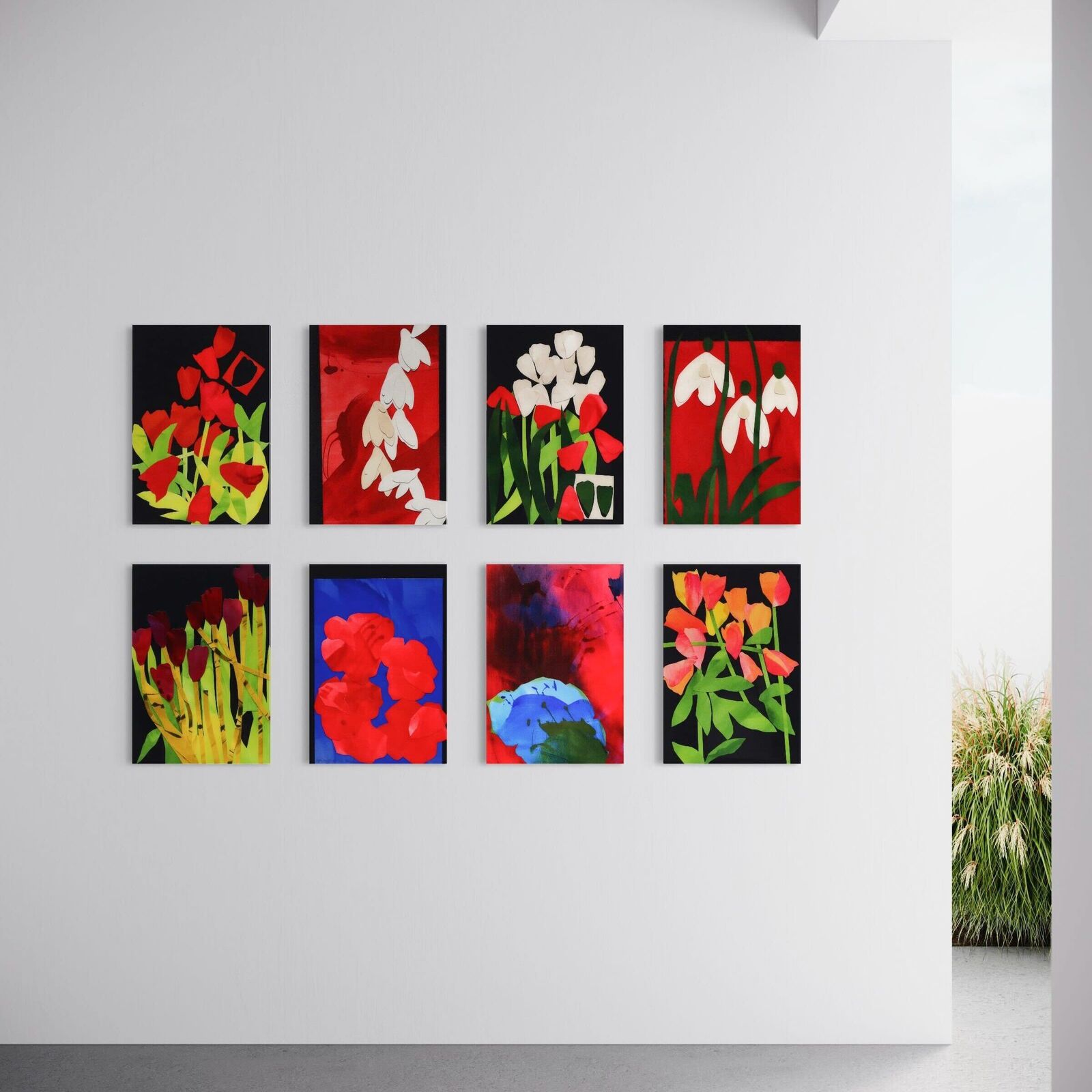 A set of six paintings of flowers on a white wall.