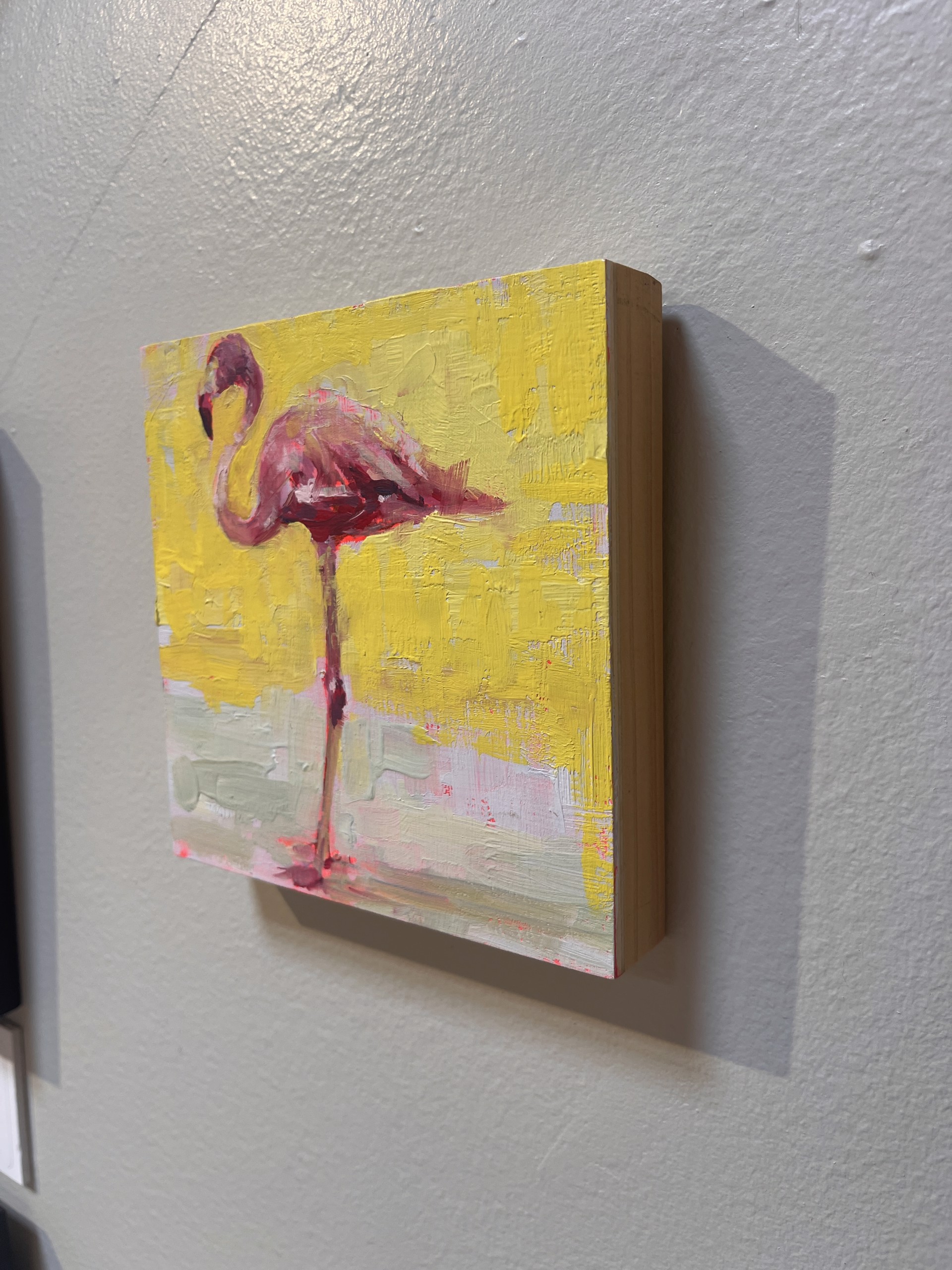 A bold, textured painting of a pink flamingo against a vibrant yellow background.
