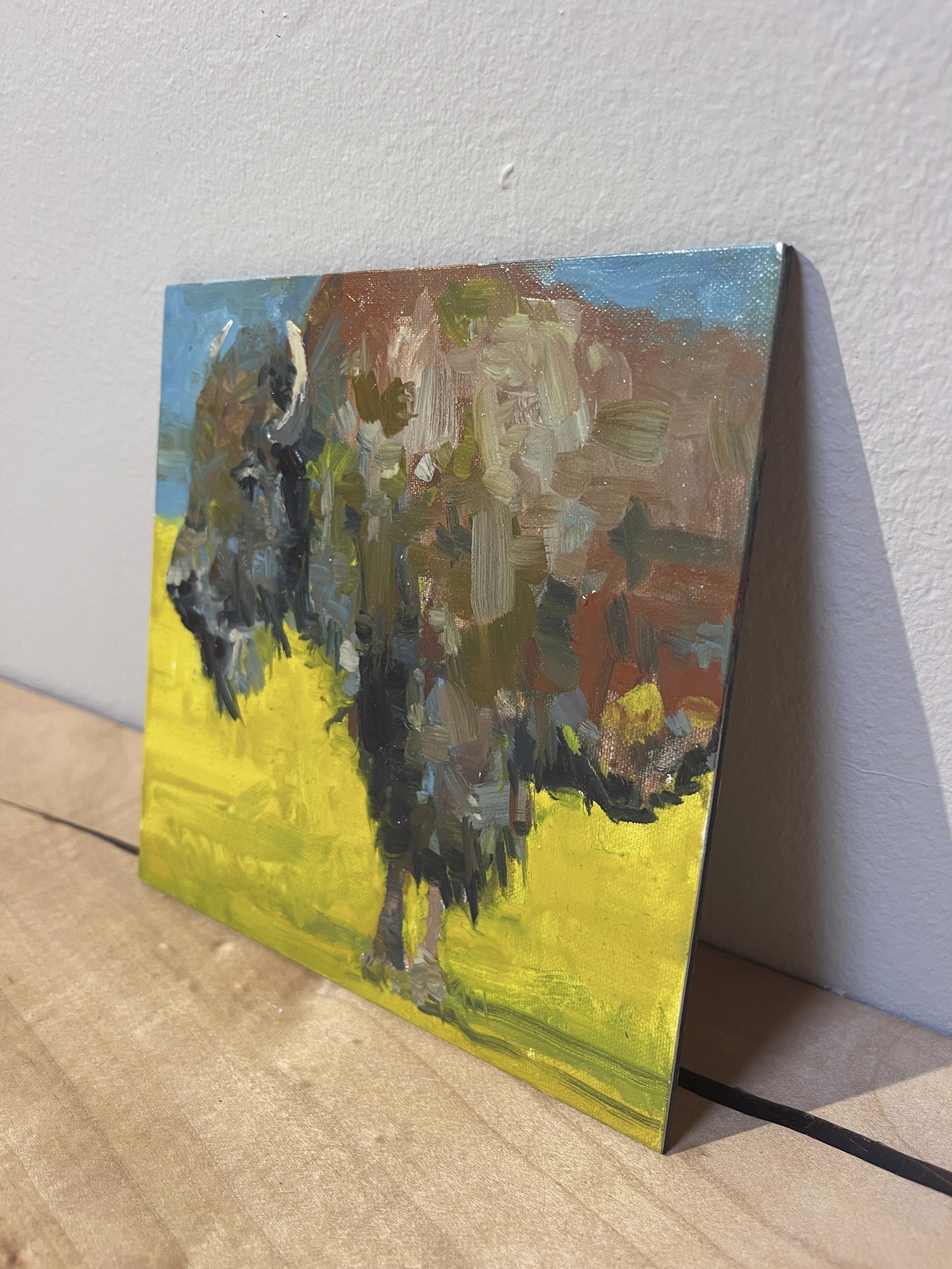 A painting of a bison standing in a field.
