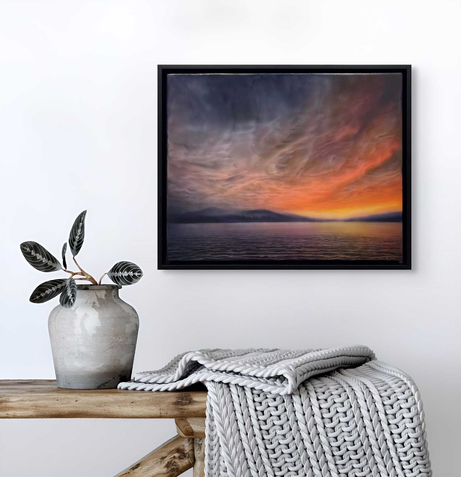 "A dramatic seascape at twilight featuring a textured sky and distant mountains."