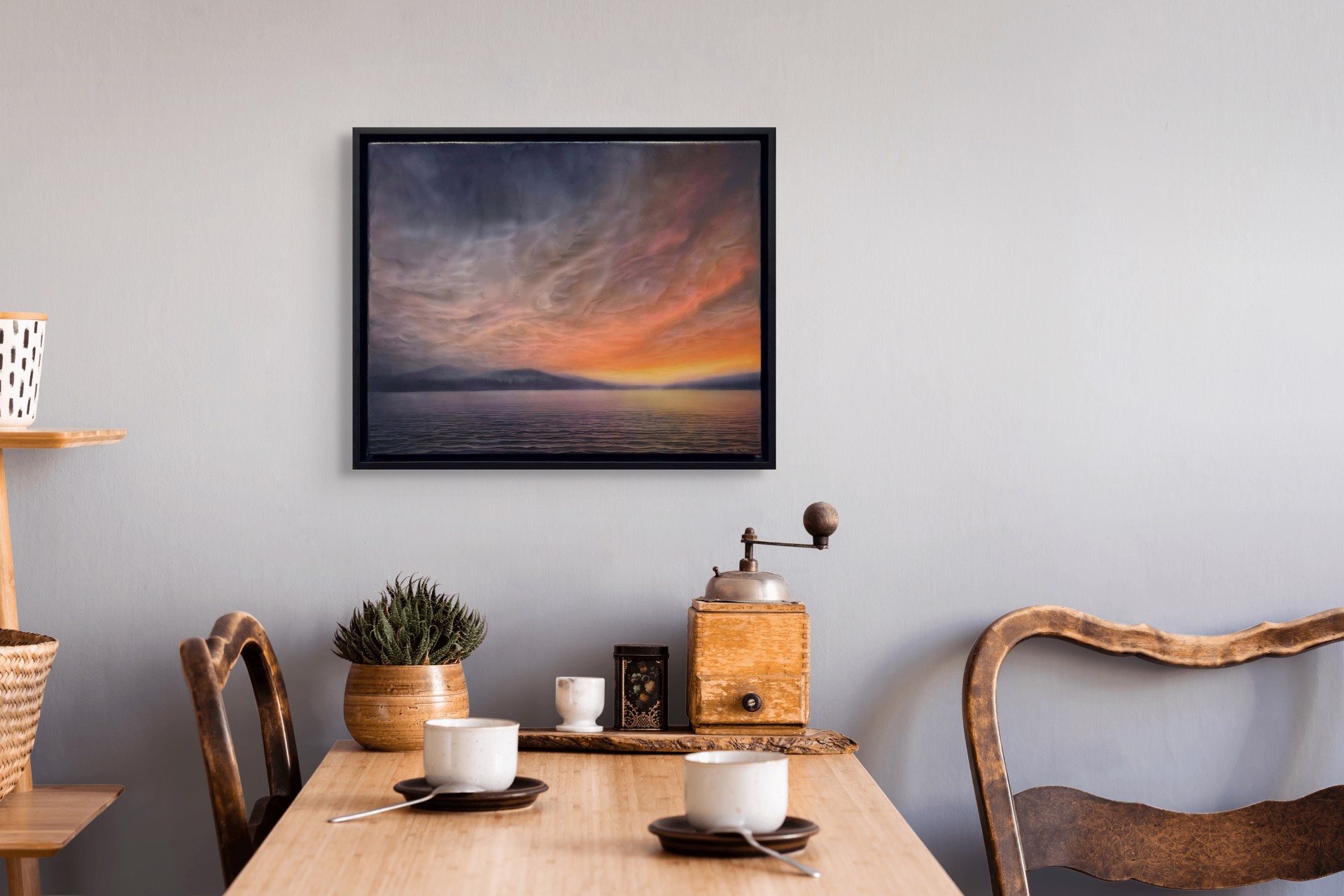 "A dramatic seascape at twilight featuring a textured sky and distant mountains."