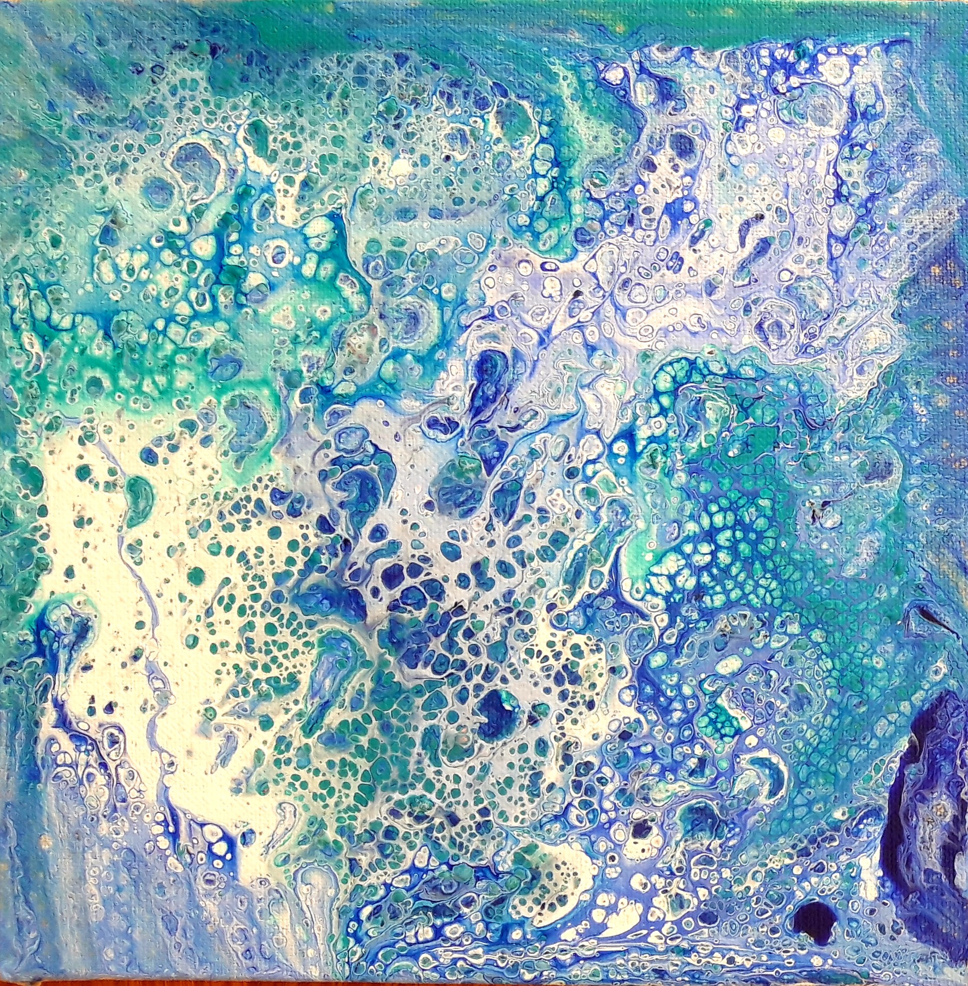 A painting of blue and white paint on a wooden surface.