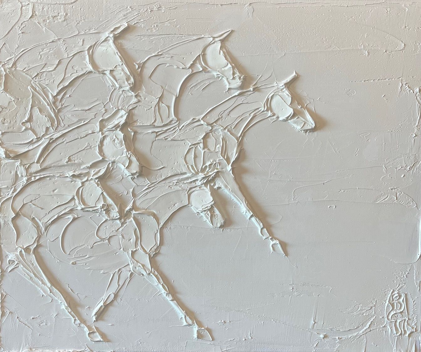 A painting of two white horses on a white wall.