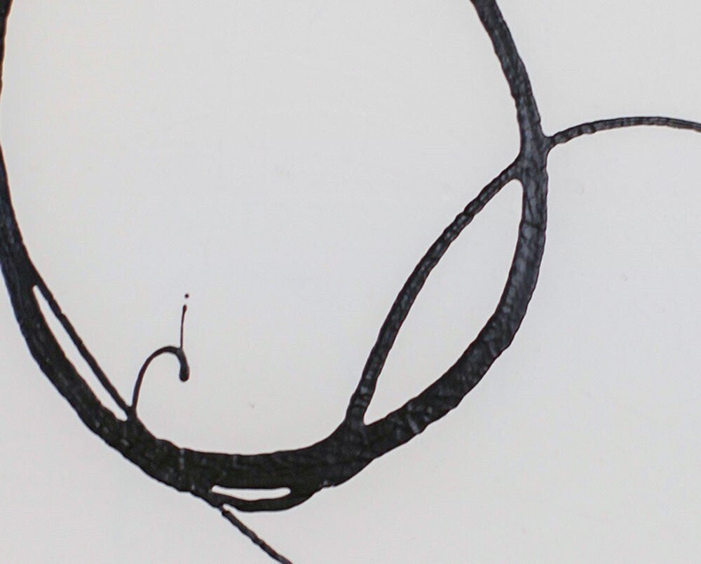 A black and white drawing of two circles on a white wall.