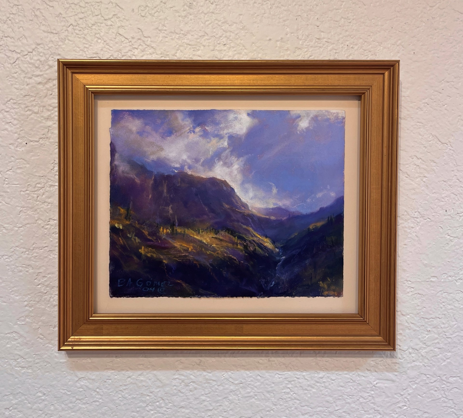 A painting of a mountain landscape with a cloudy sky.