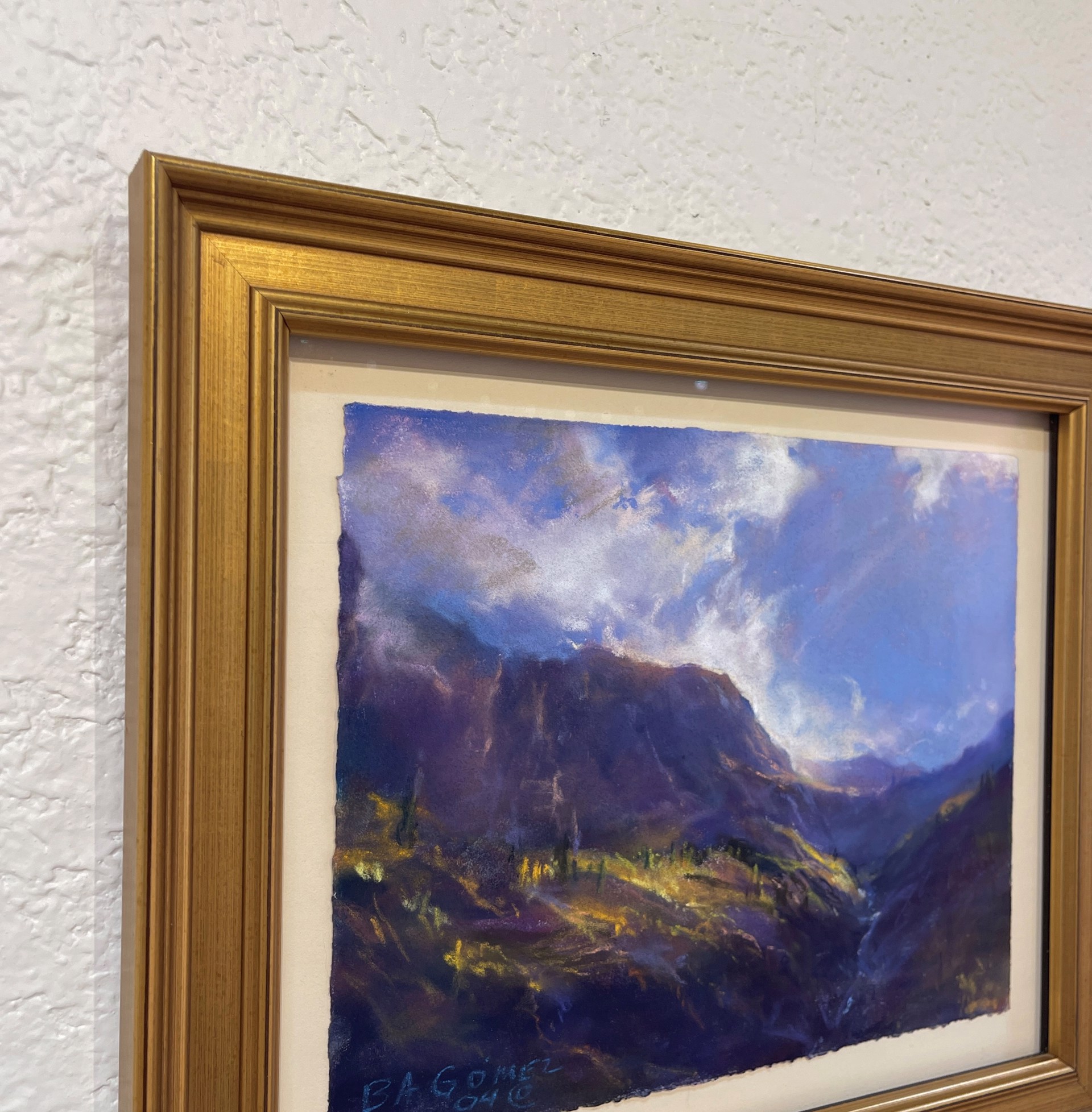 A painting of a mountain landscape with a cloudy sky.