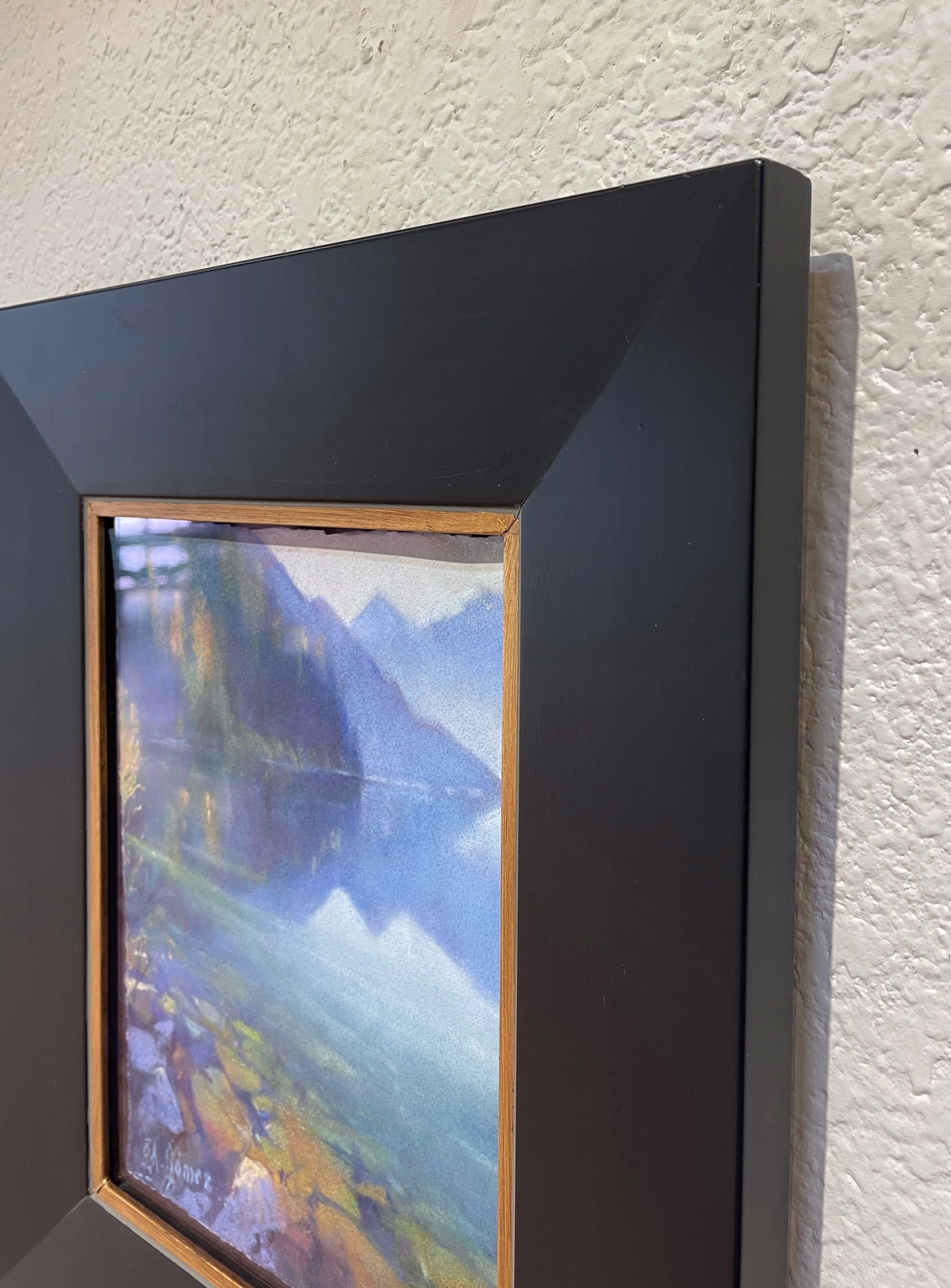 A painting of a lake with mountains in the background.