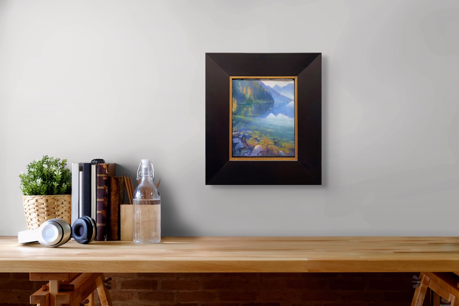 A painting of a lake with mountains in the background.