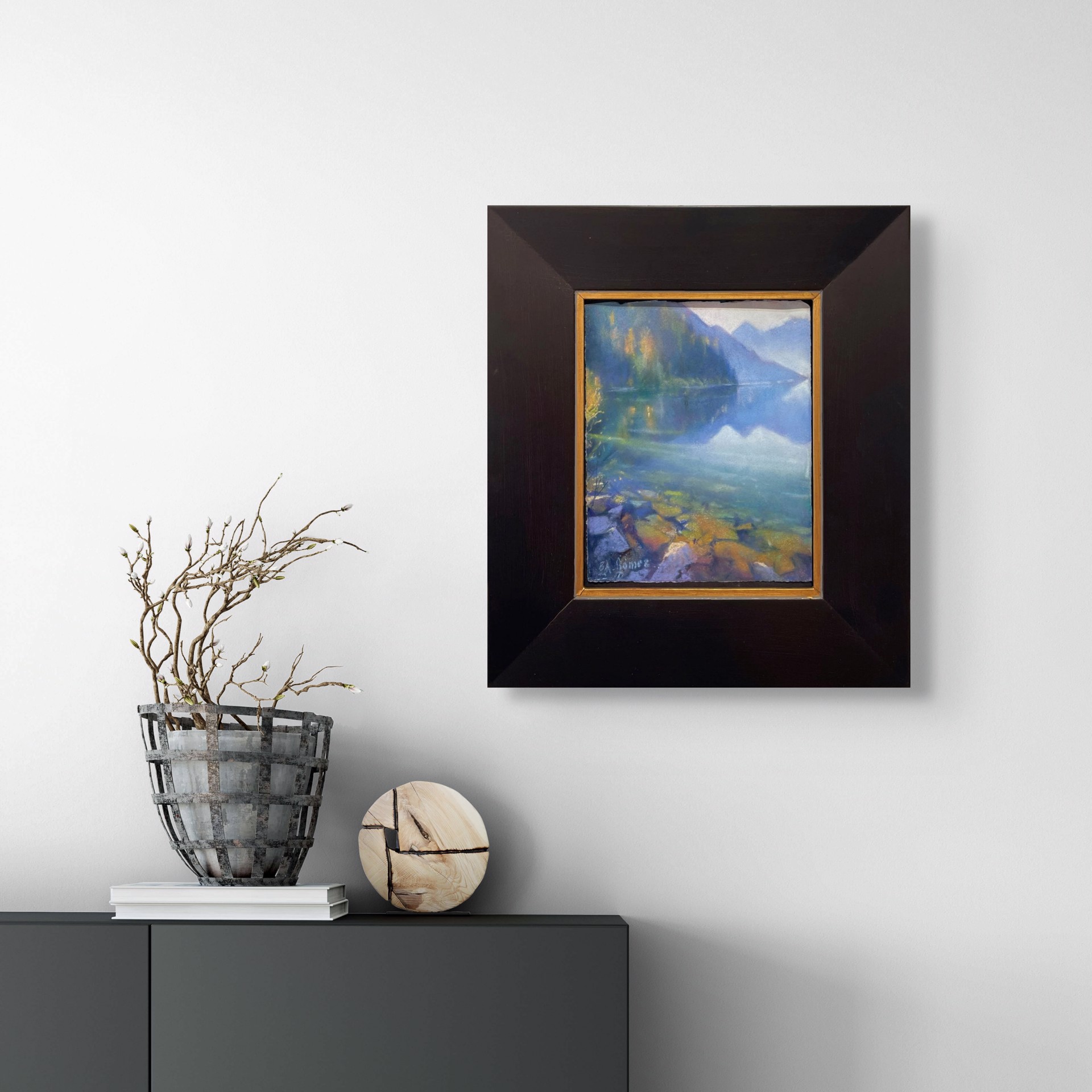 A painting of a lake with mountains in the background.