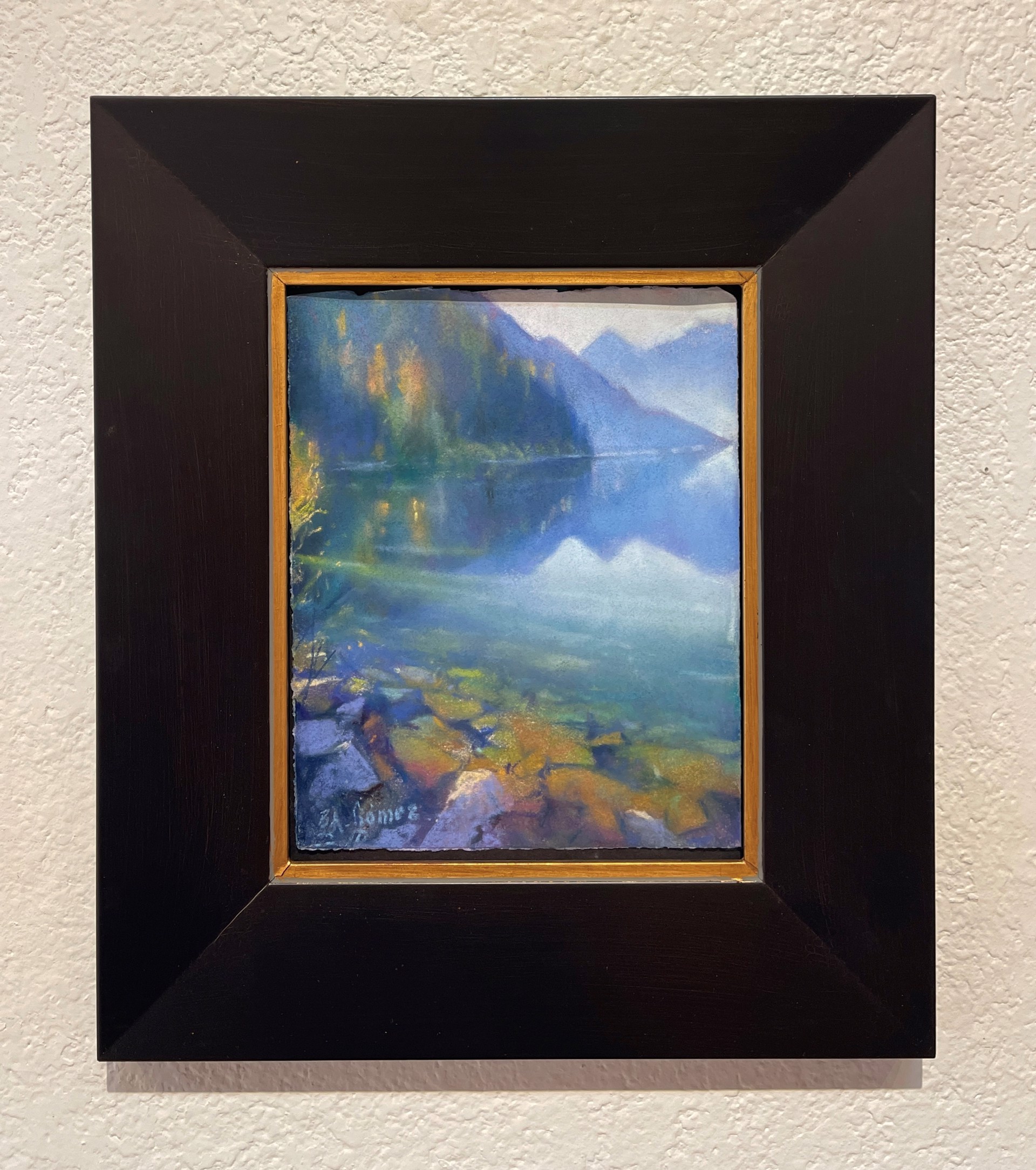 A painting of a lake with mountains in the background.