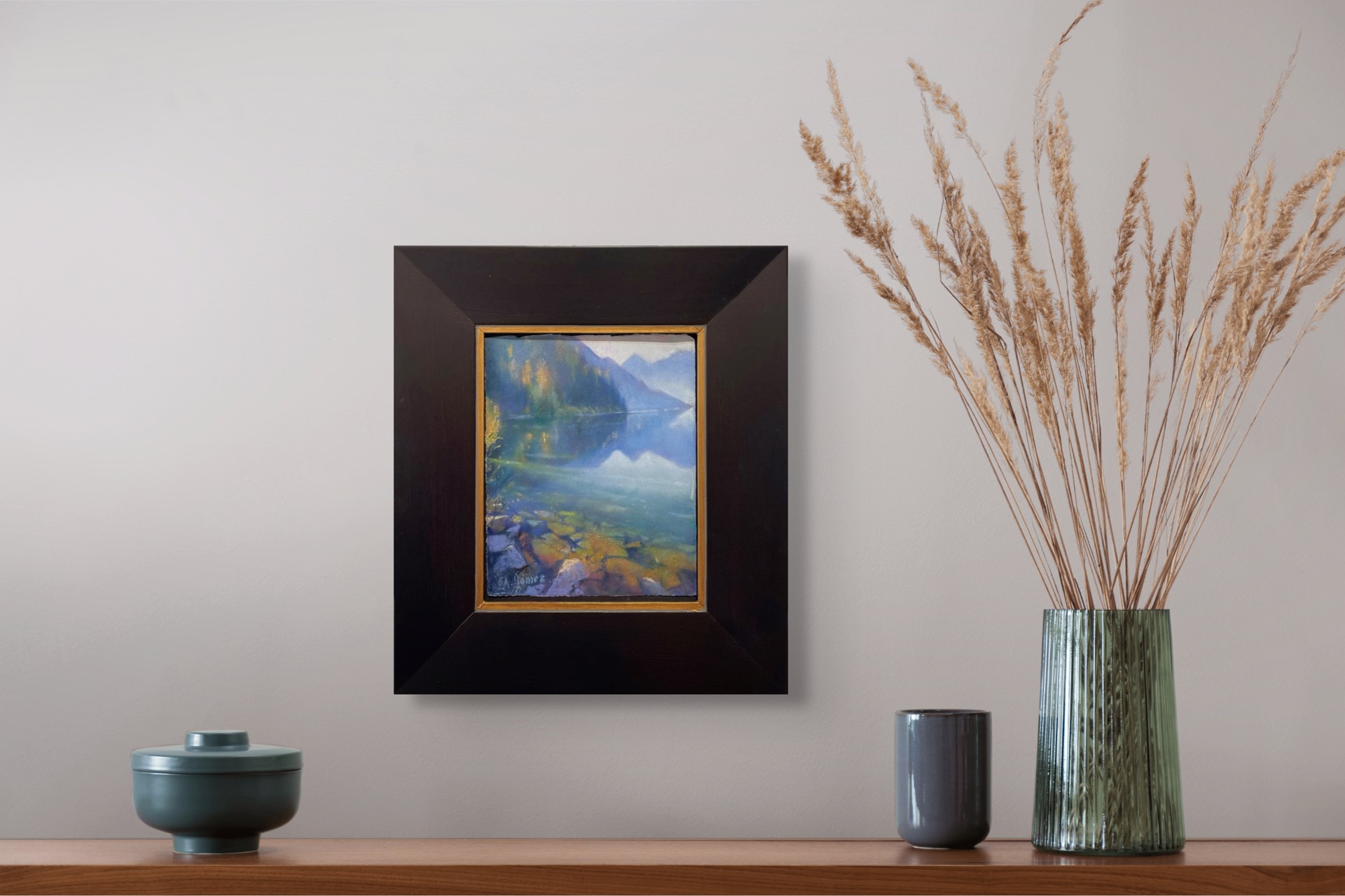 A painting of a lake with mountains in the background.