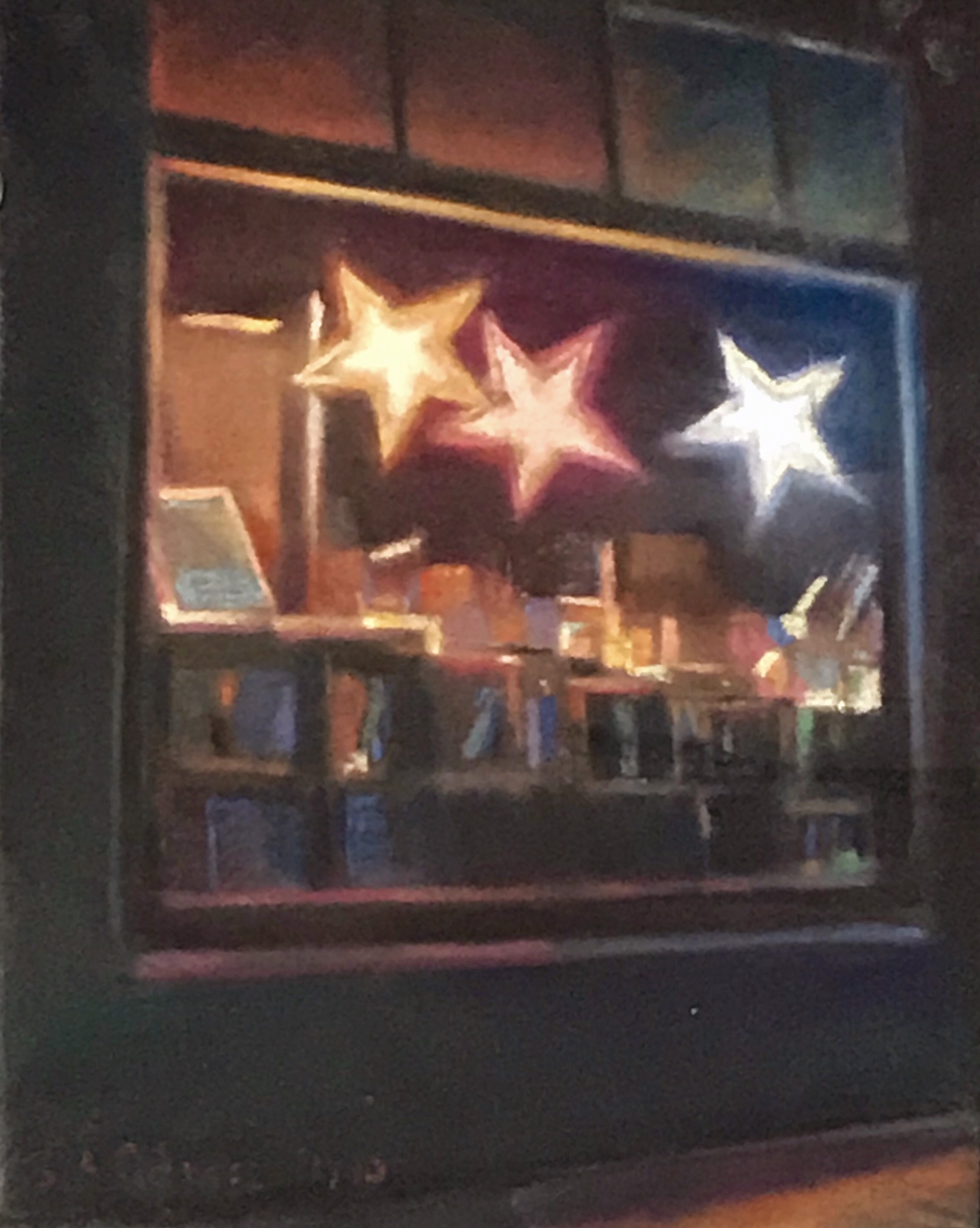 A painting of three stars in a window of a store.