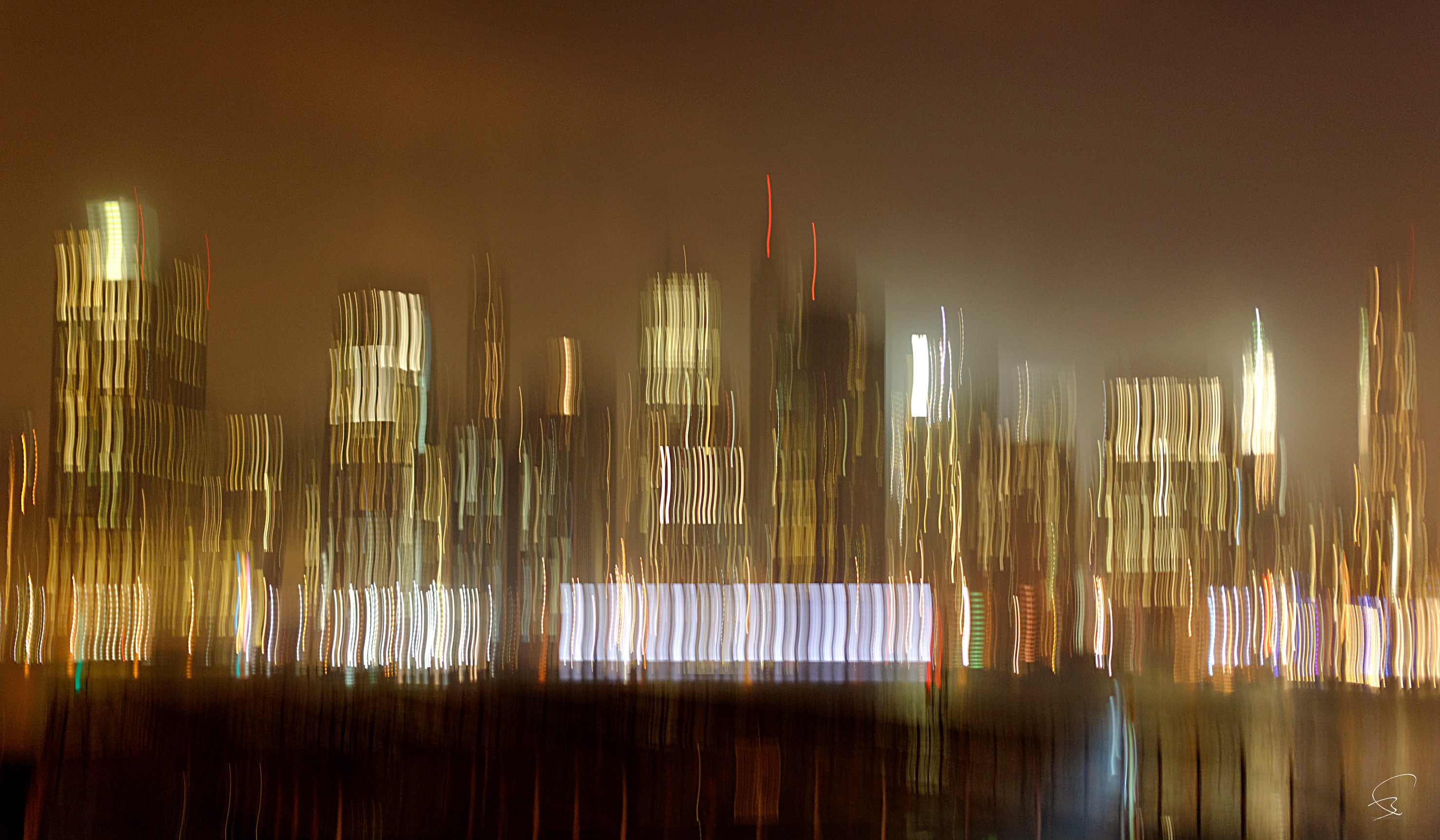 A blurry image of a city skyline at night.