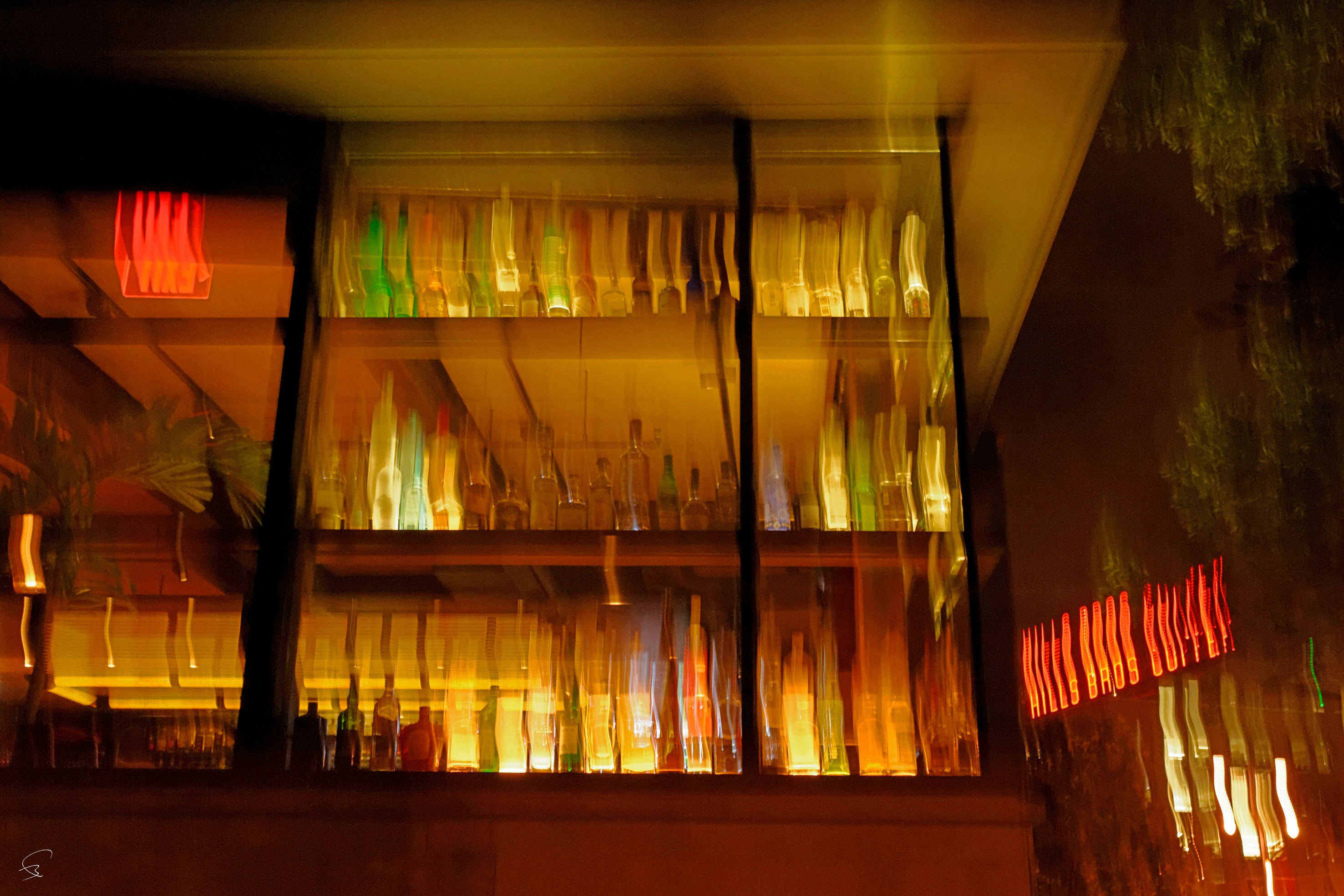 A display case filled with lots of different colored glass bottles.