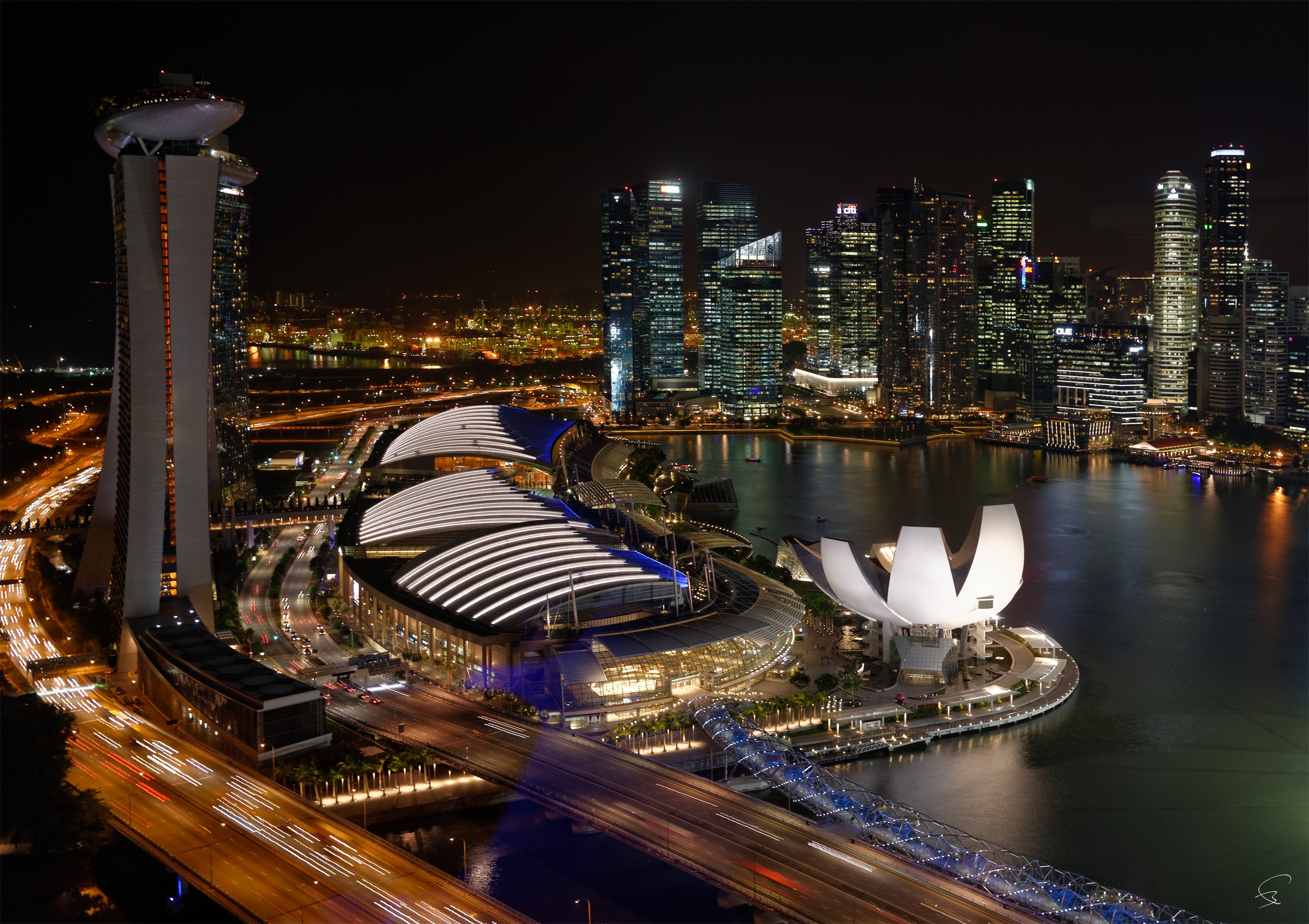 A view of a city at night from the top of a building.