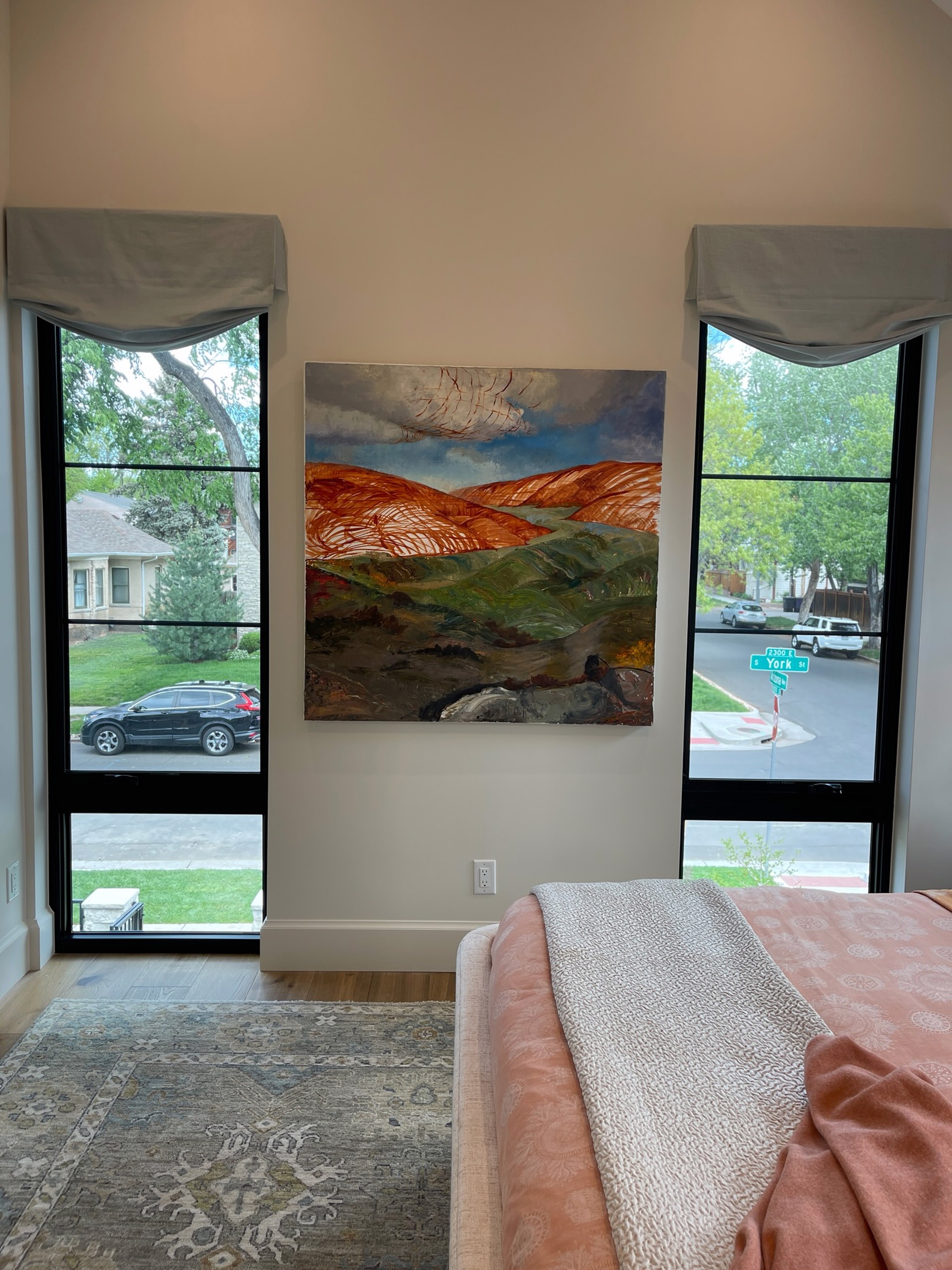 A painting of a landscape with hills in the background.