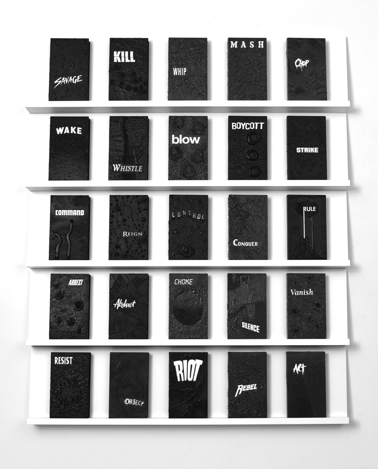 A white shelf with a bunch of black and white books on it.
