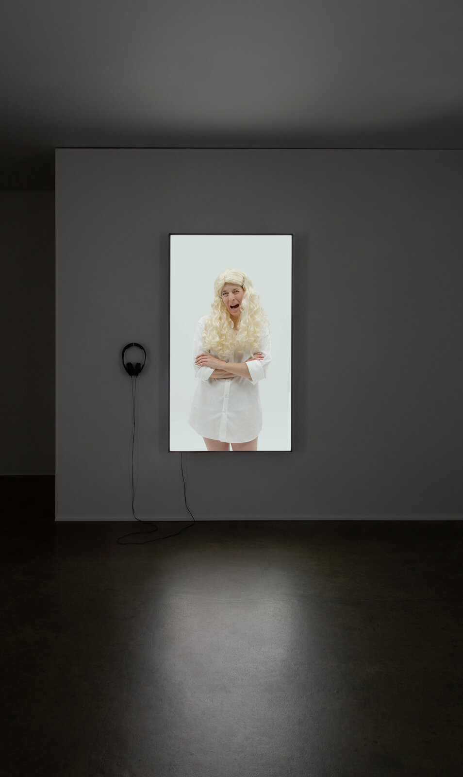 A picture of a woman in a white dress on a wall.