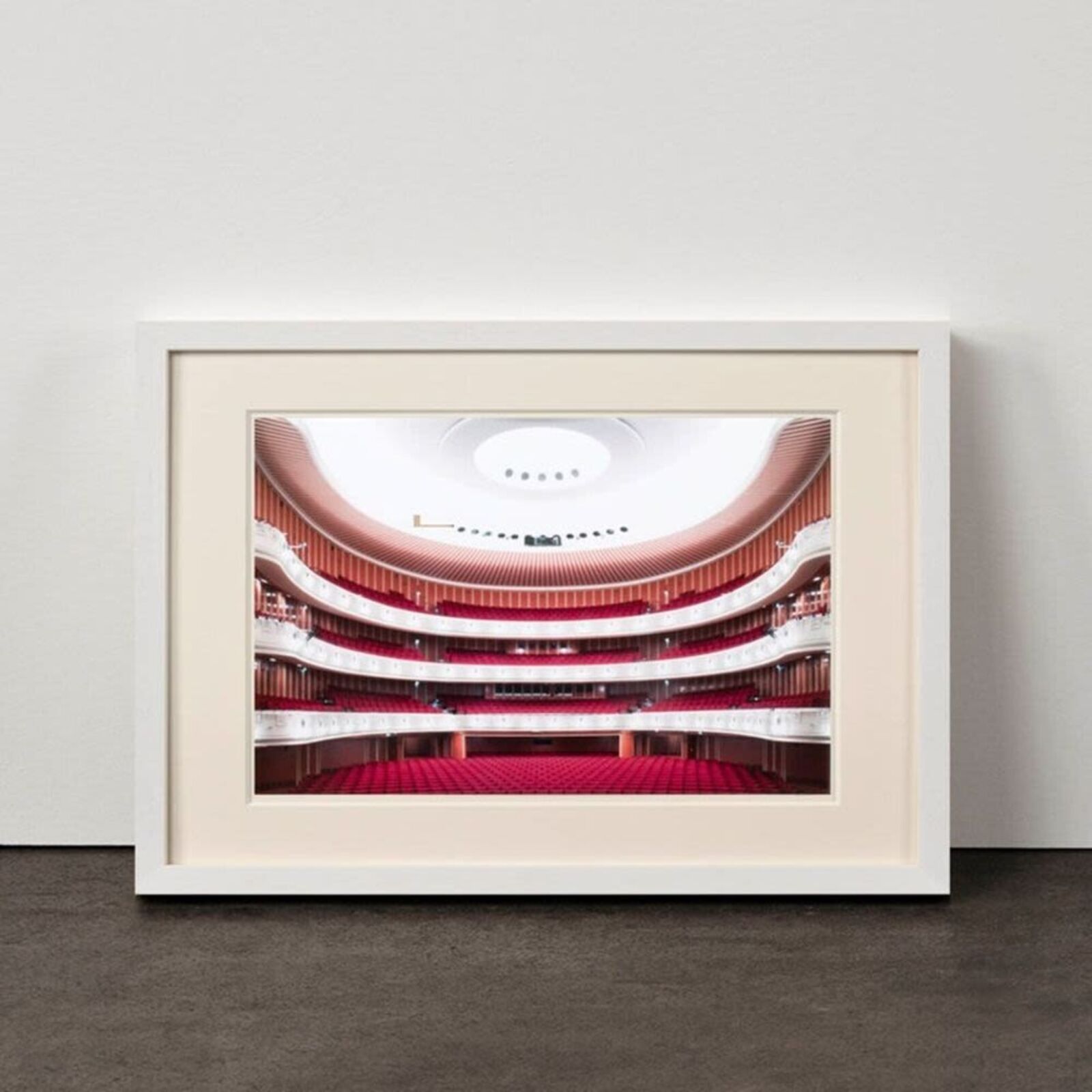 A picture of a large auditorium with red seats.