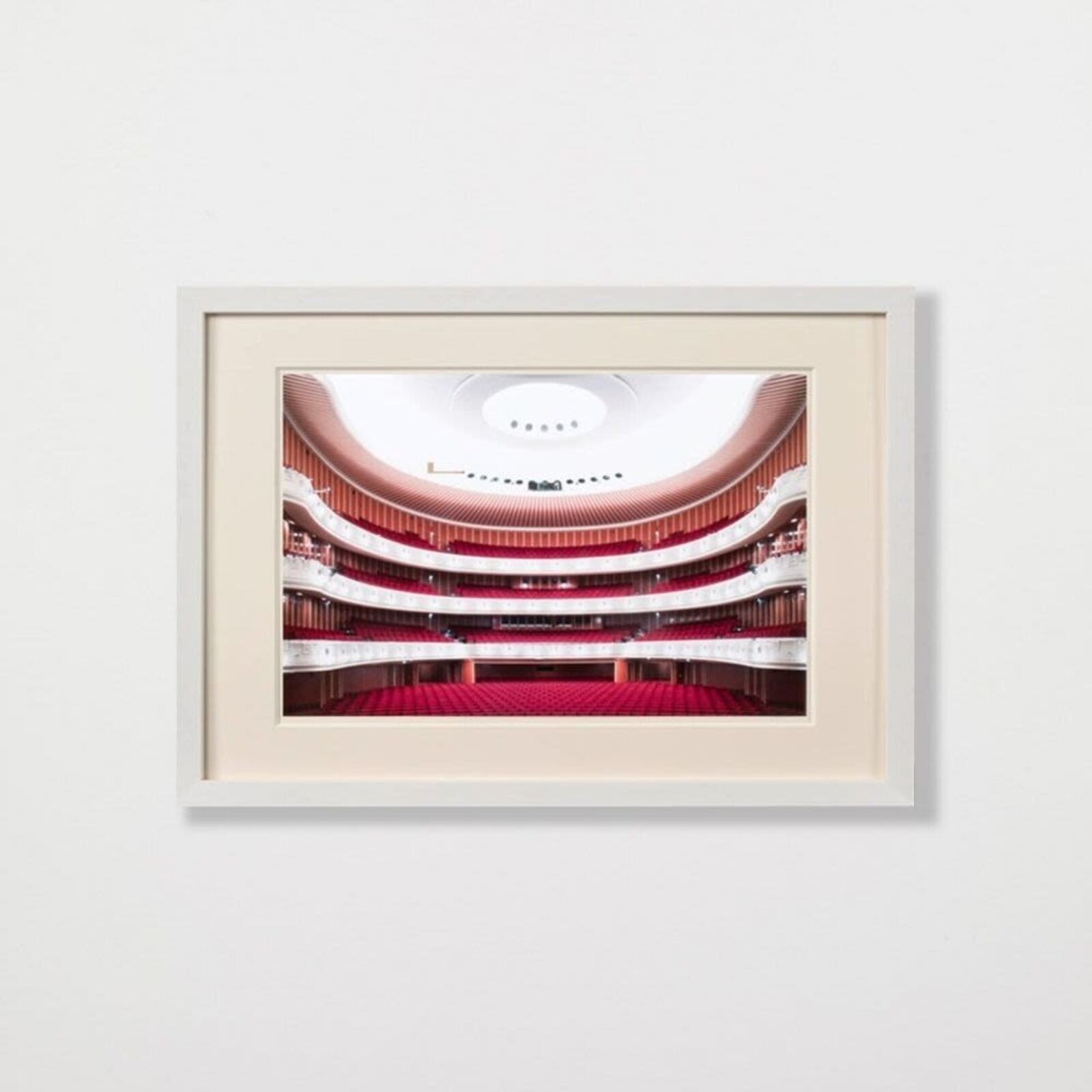 A picture of a large auditorium with red seats.