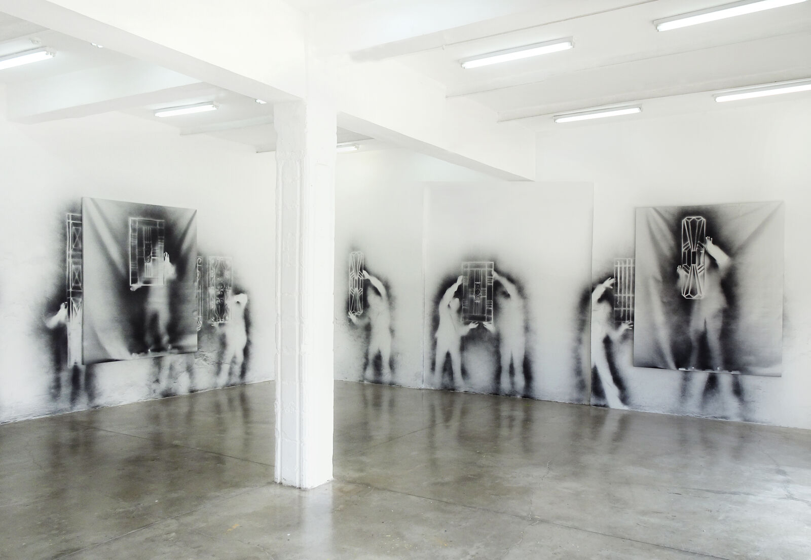 A black and white photo of a person standing in front of a jail cell.