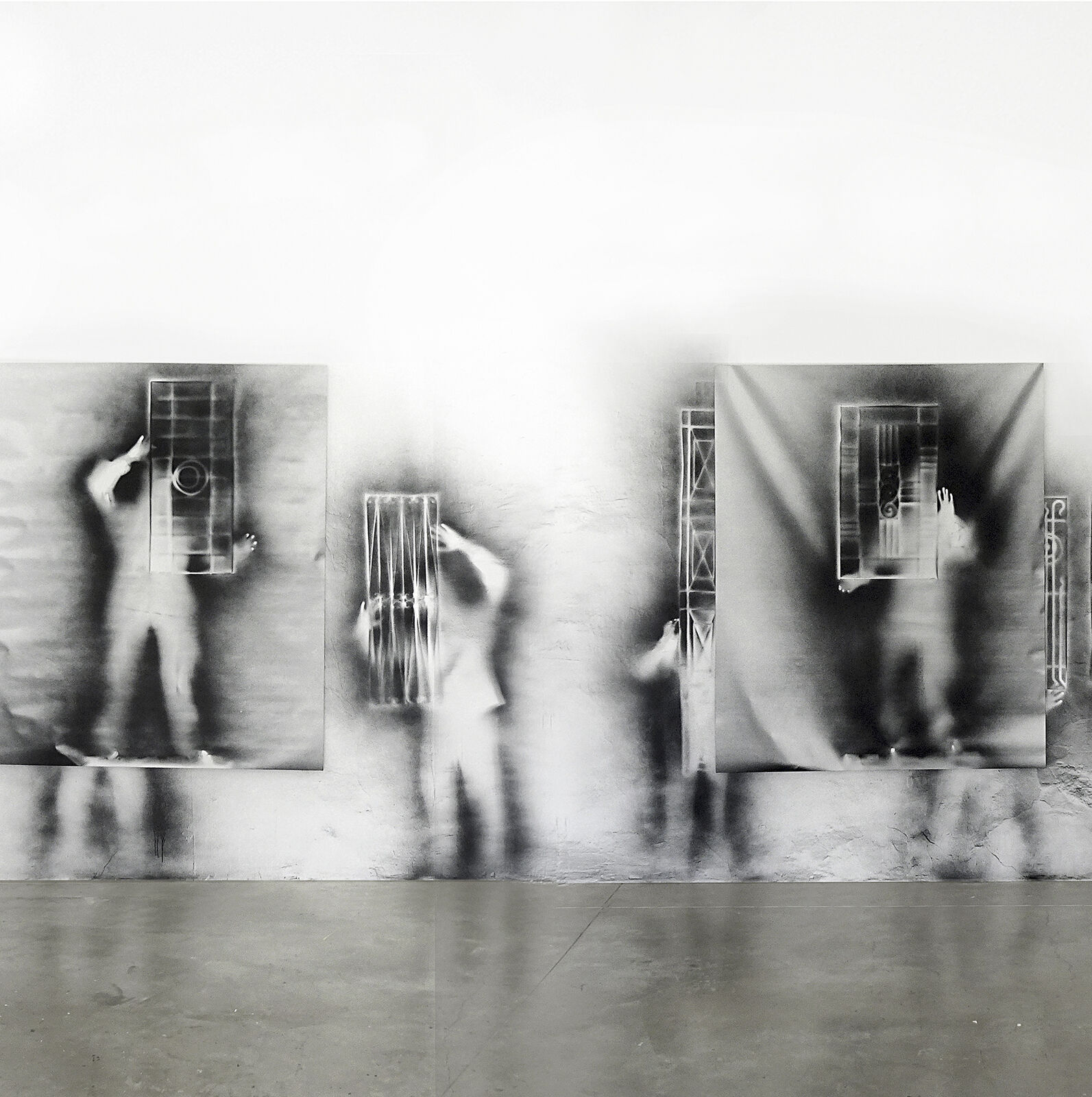 A black and white photo of a person standing in front of a mirror.