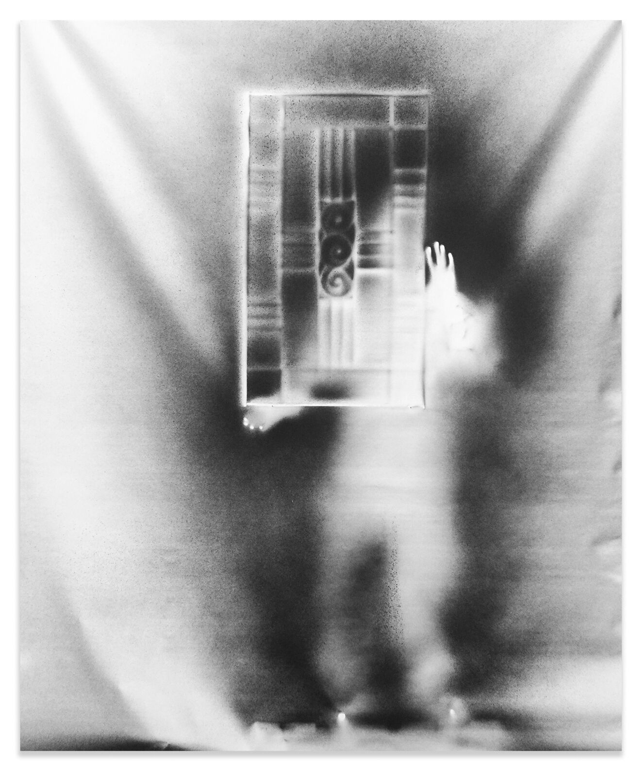 A black and white photo of a person standing in front of a mirror.