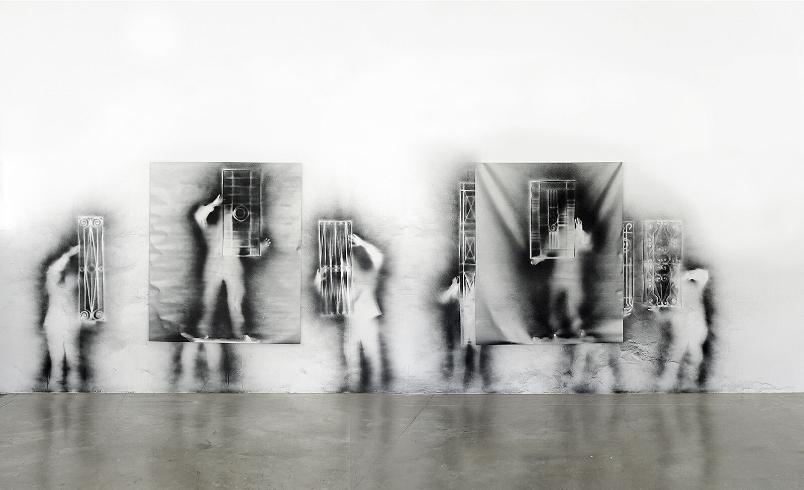 A black and white photo of a person standing in front of a mirror.