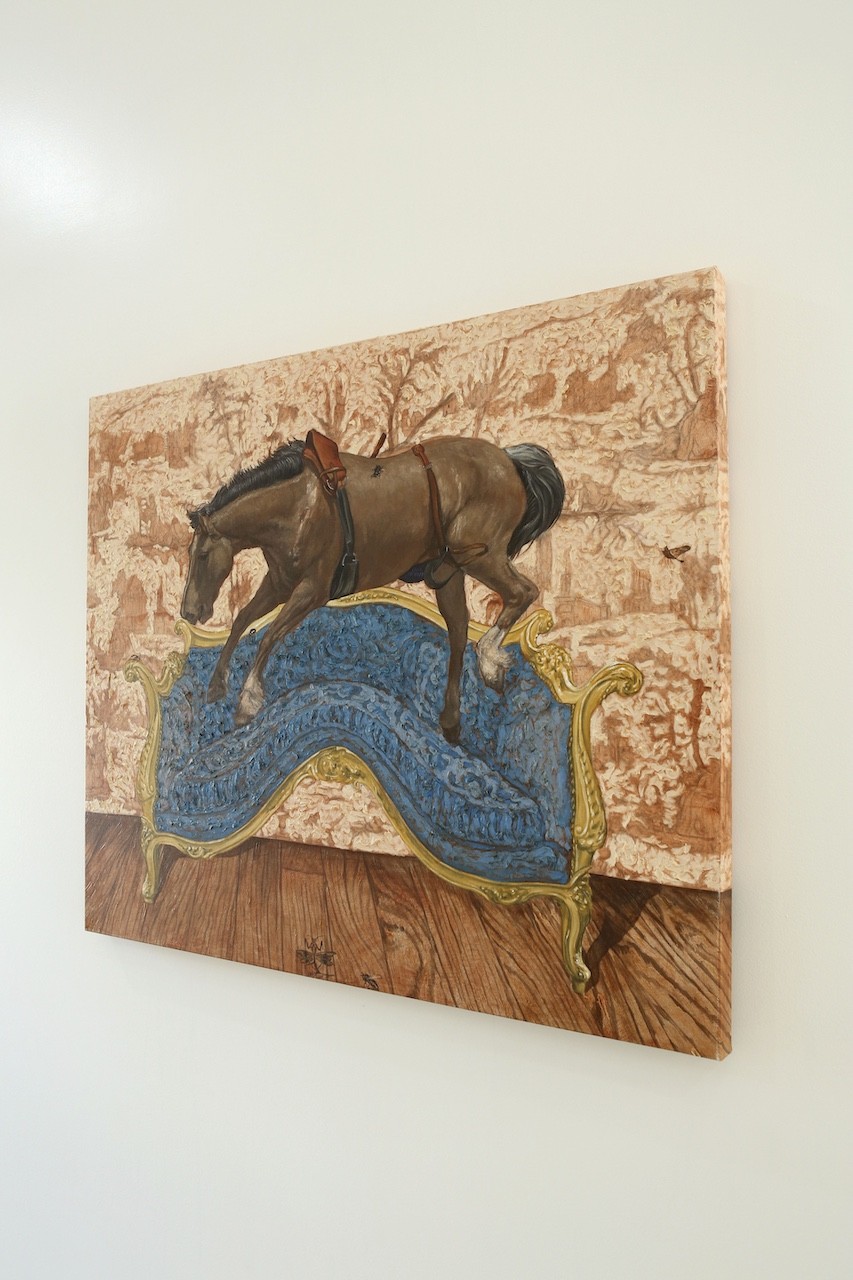 A painting of a horse on a couch in a room.