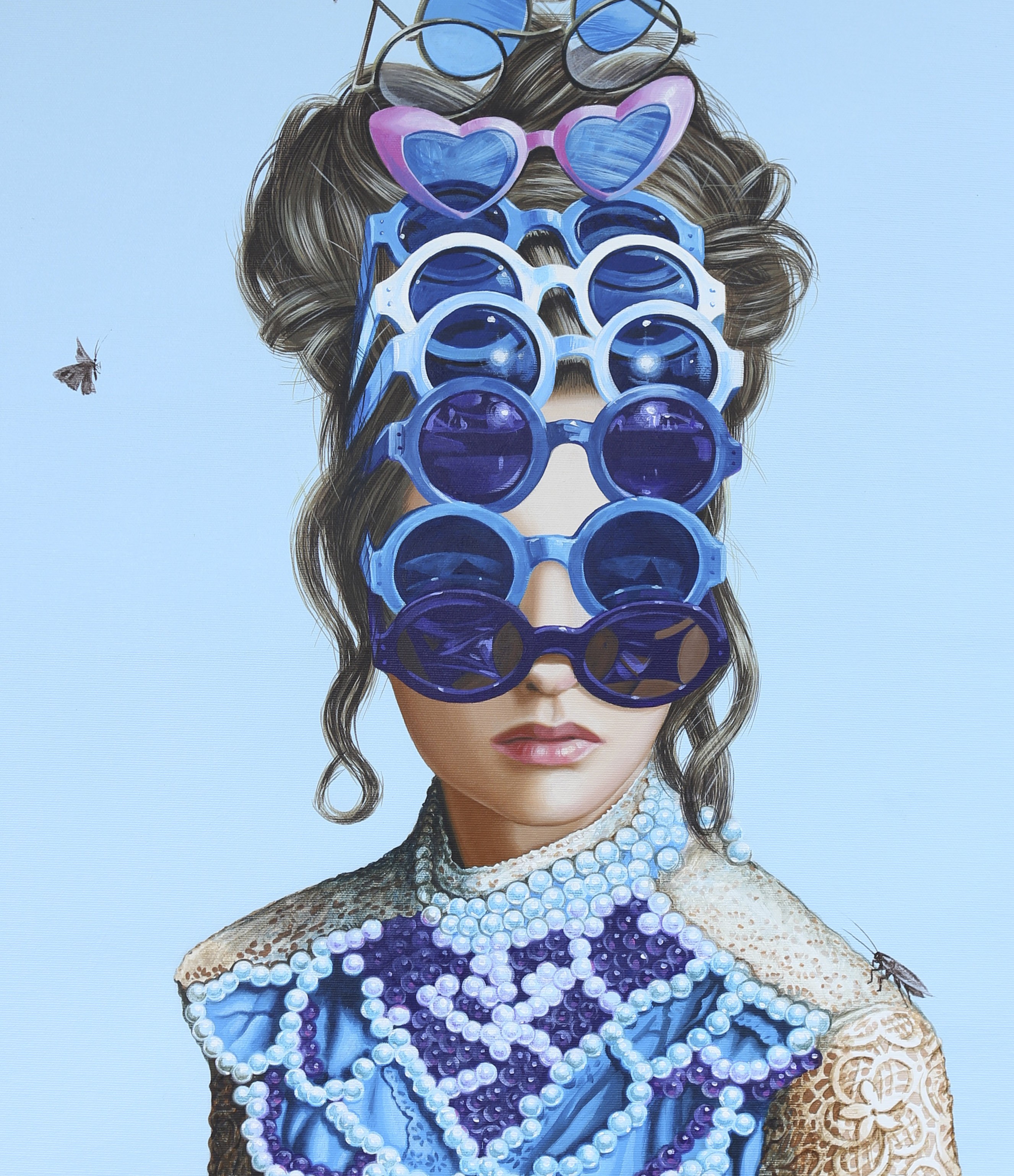 A painting of a woman wearing sunglasses on a wall.