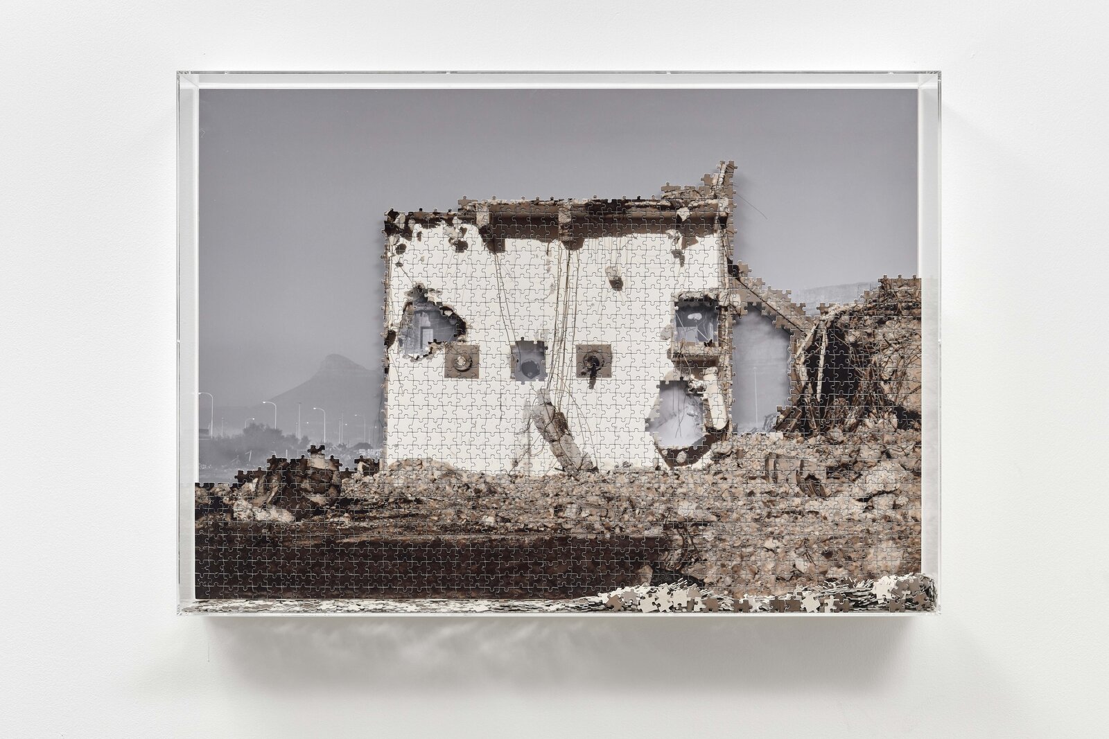 Artwork by Carlos Garaicoa, From the series Puzzles: Table and Lyon Mountain, Made of Black and white photograph printed on puzzle, photograph laminated in Dibond, wood, plexiglass 