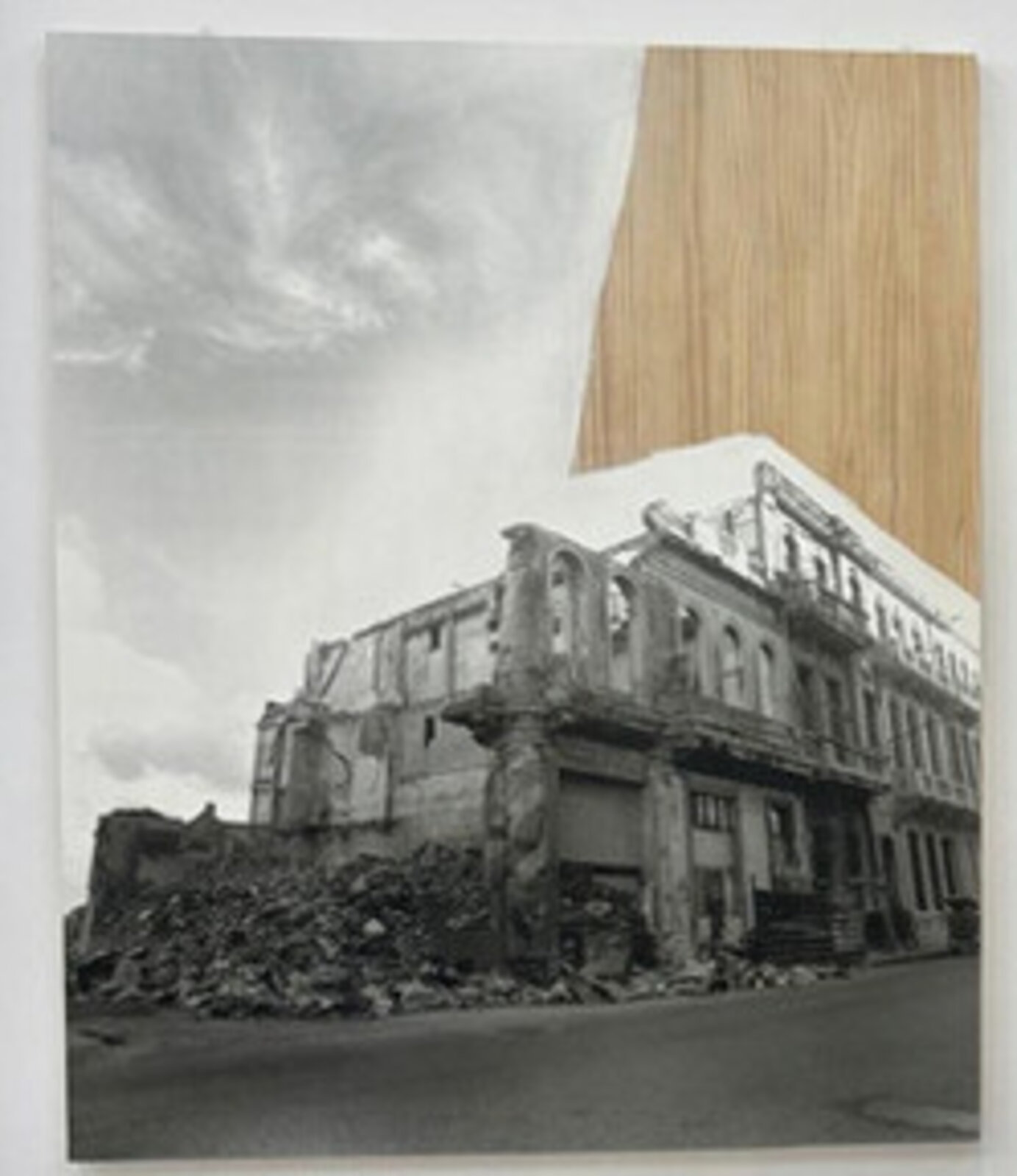 A surreal urban scene where a dilapidated building meets a smooth wooden surface.
