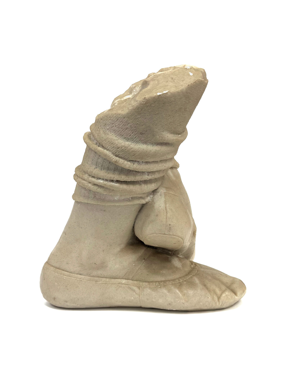 A pair of beige shoes with a hat on top of them.
