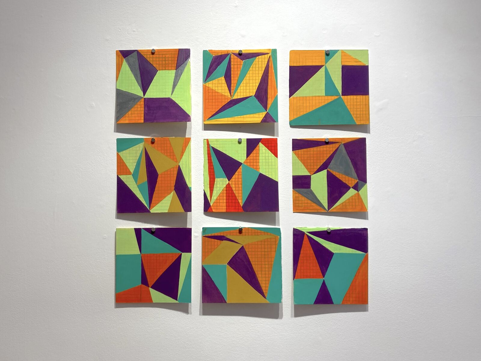 A vibrant geometric composition of interlocking triangles in bold colors.