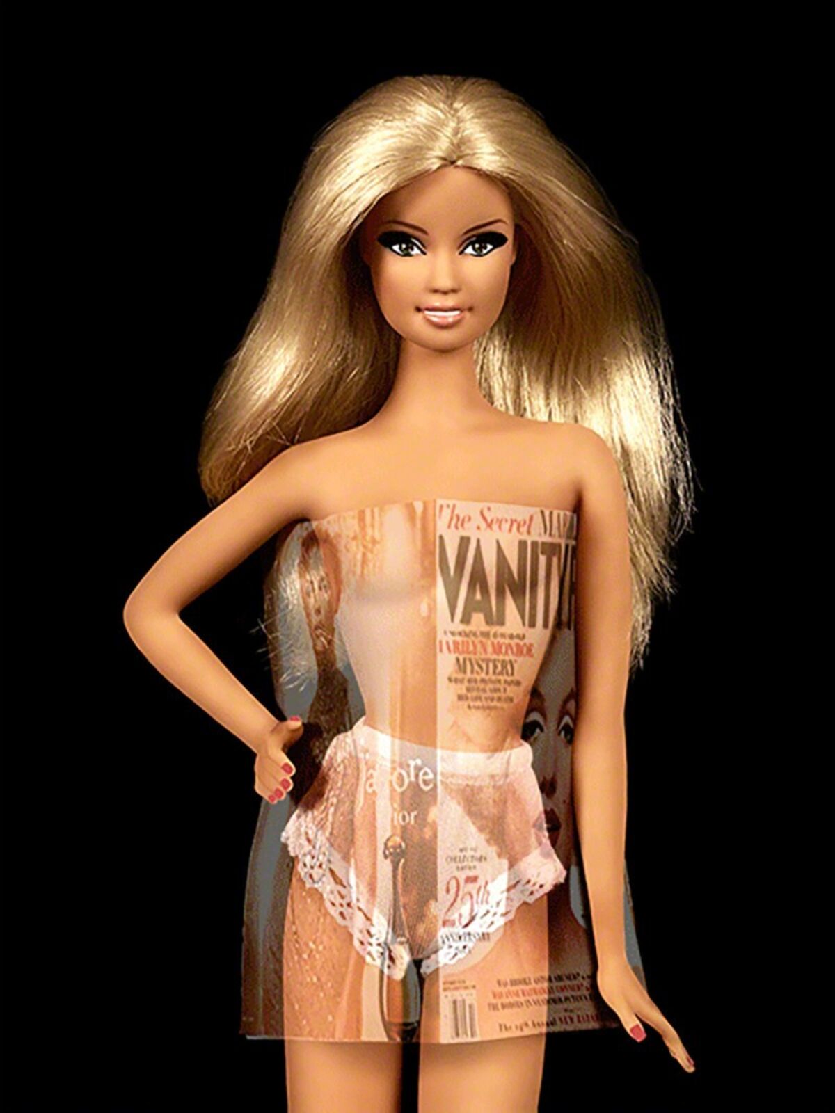 A barbie doll with blonde hair holding a magazine.