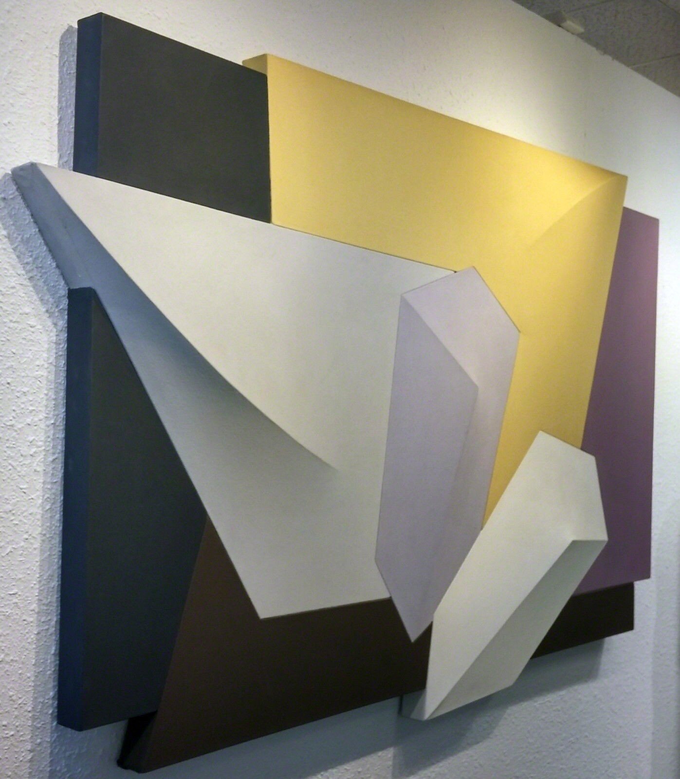 A group of different colored metal shapes on a white background.