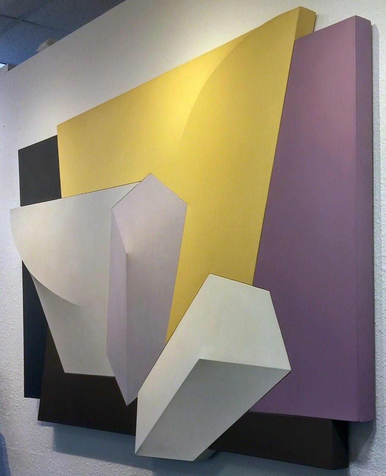 A group of different colored metal shapes on a white background.