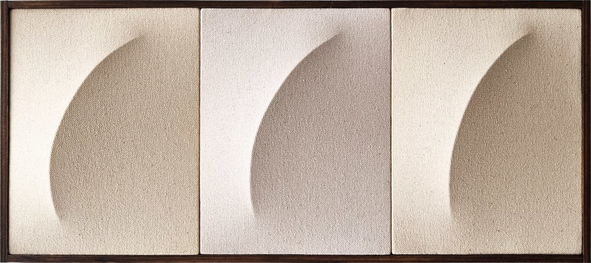 A picture of three different shapes in a wooden frame.