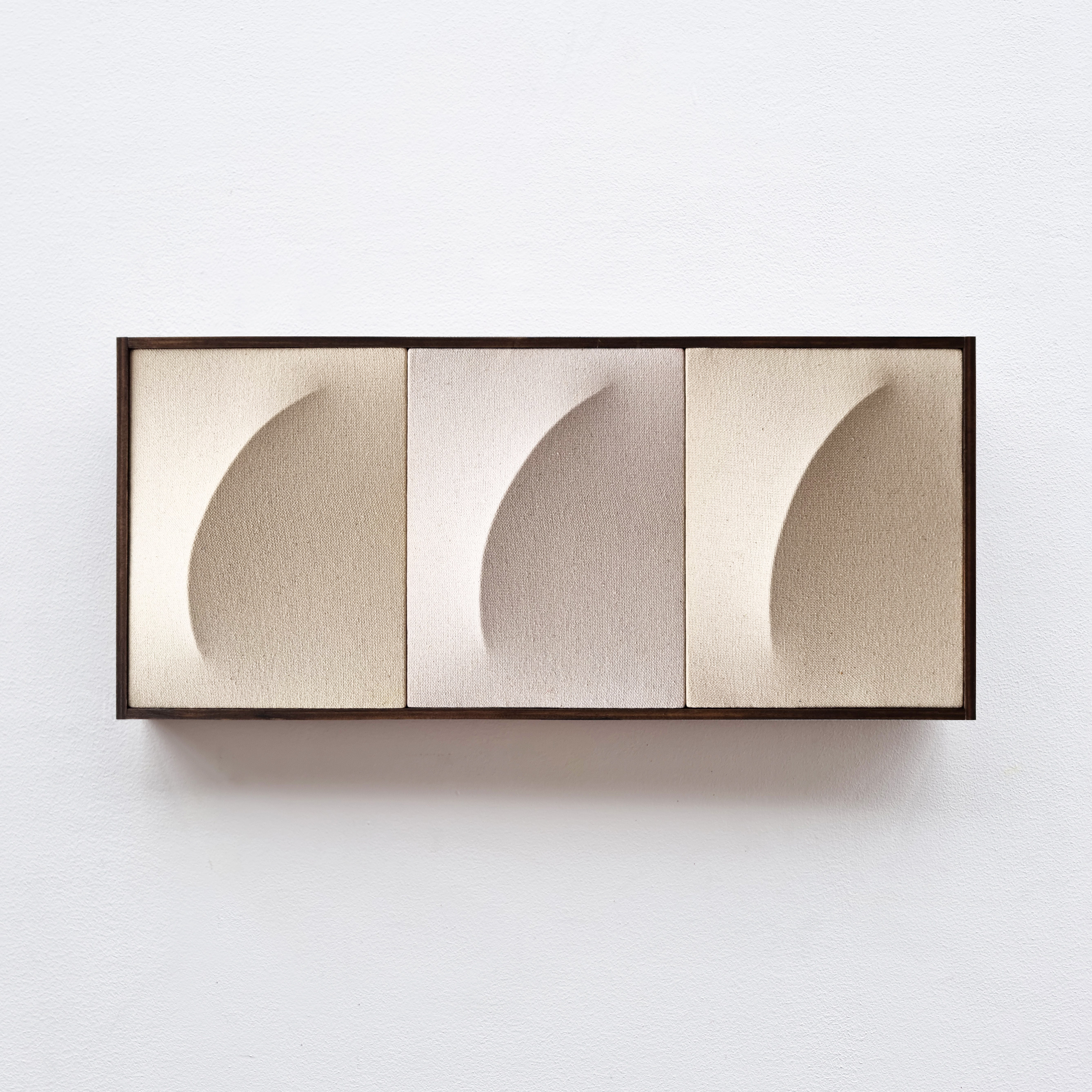 A picture of three different shapes in a wooden frame.
