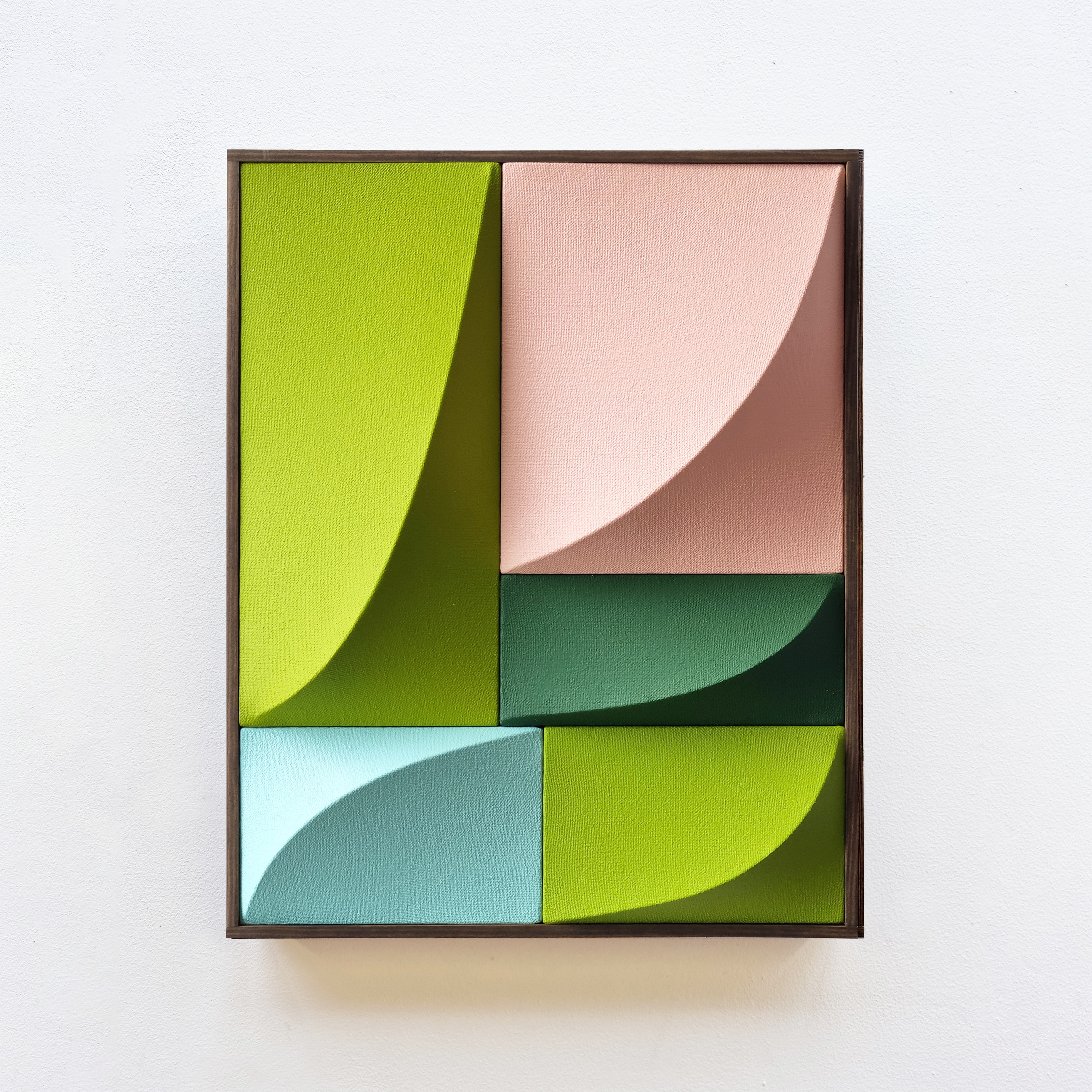 A picture of a green, pink, and blue abstract painting on a wall.