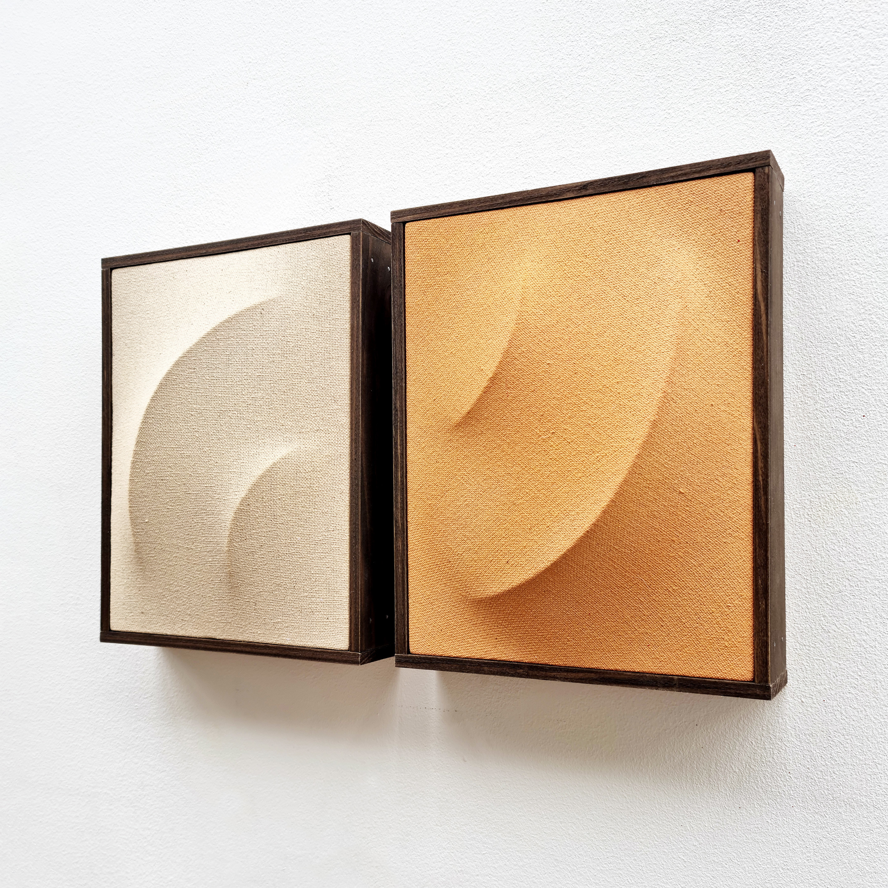 A picture of a painting in a wooden frame on a wall.