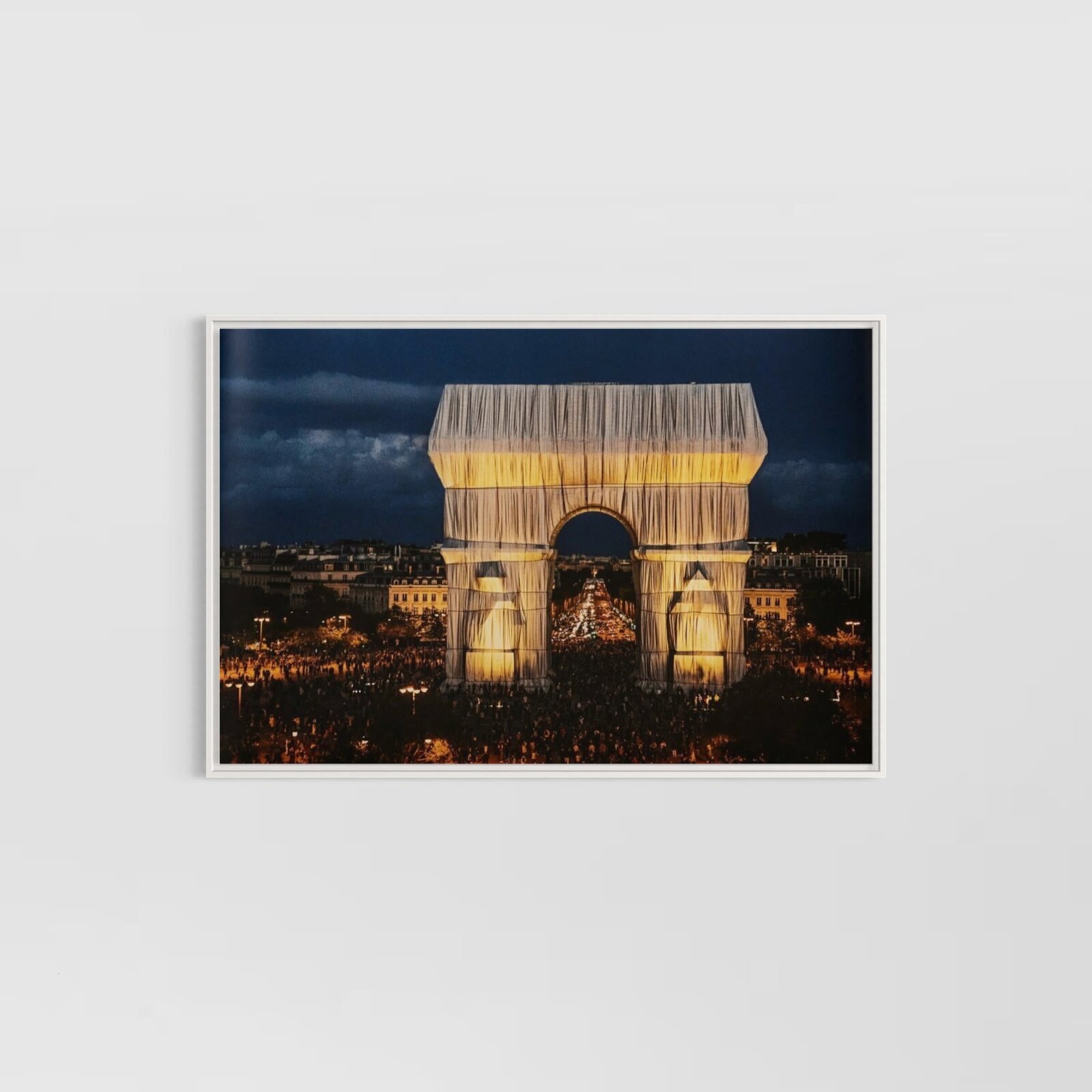 A massive archway draped in flowing fabric, illuminated against a dark night sky.