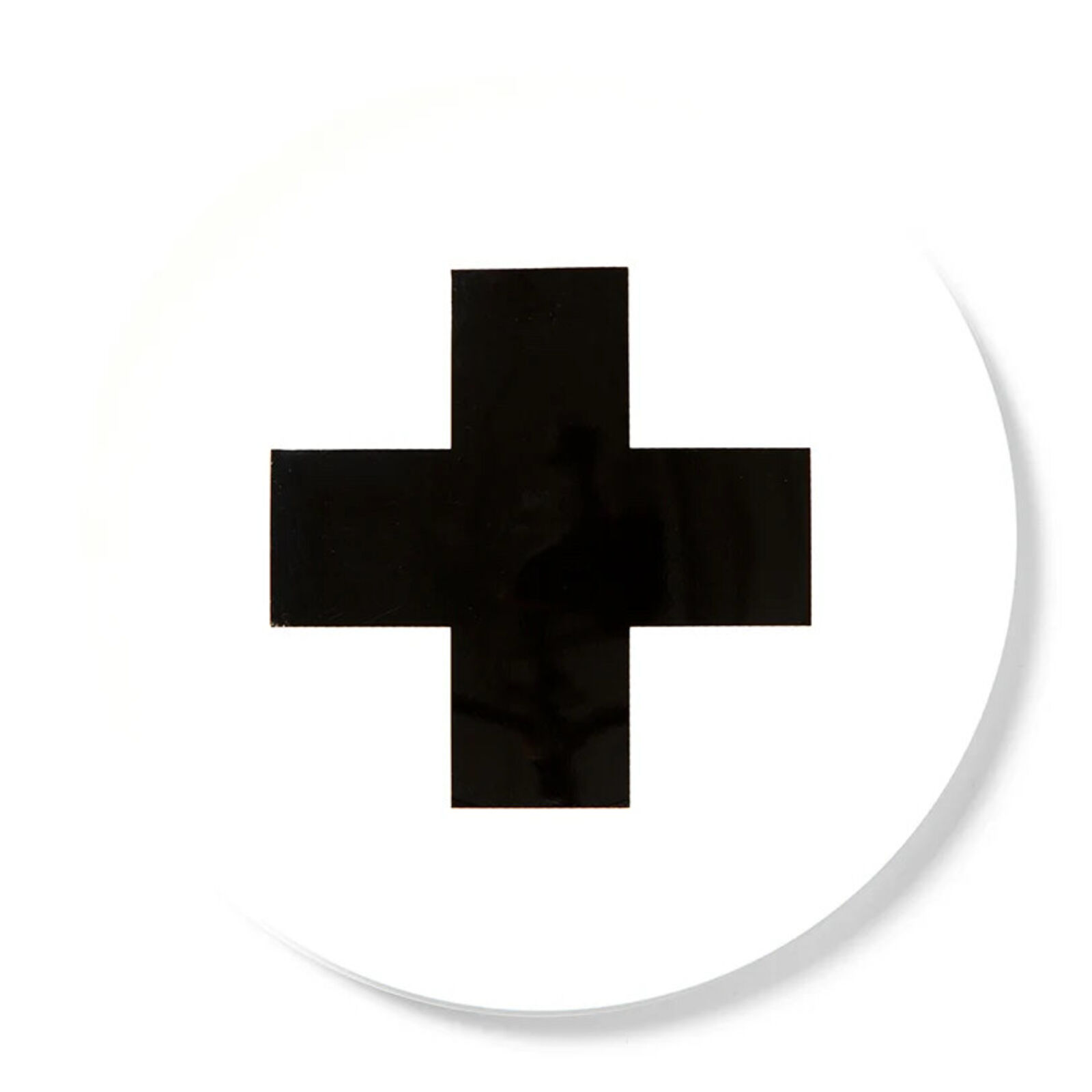 A black cross on a white circle with a white background.